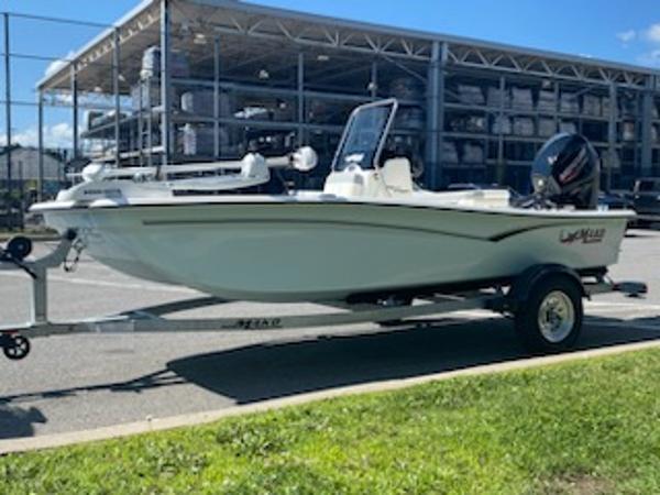 2024 Mako Pro Skiff 15 CC boat on trailer, parked outdoors.