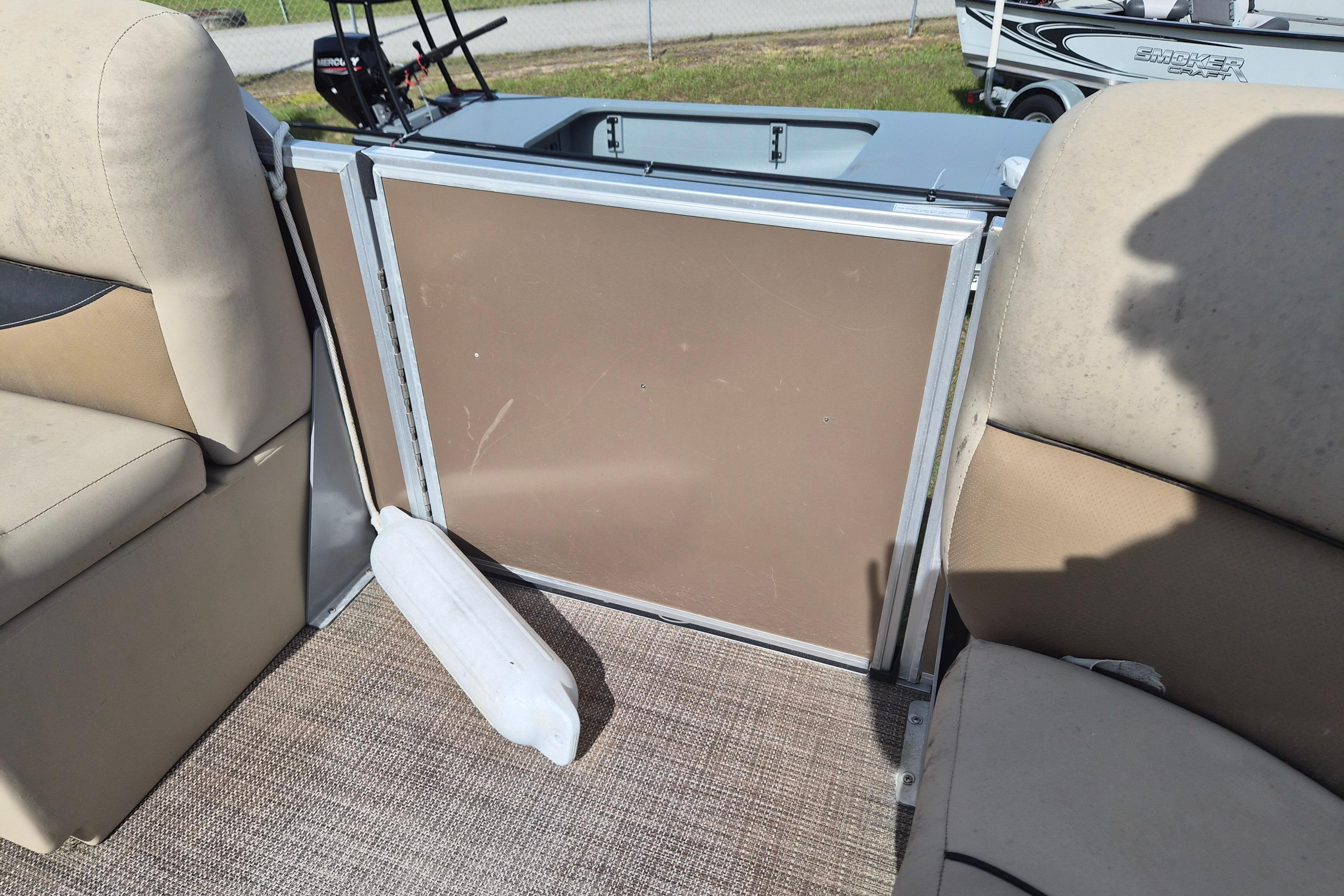 Interior of a 2004 Bentley Pontoons 180 CRUISE with beige seating and a boat fender.