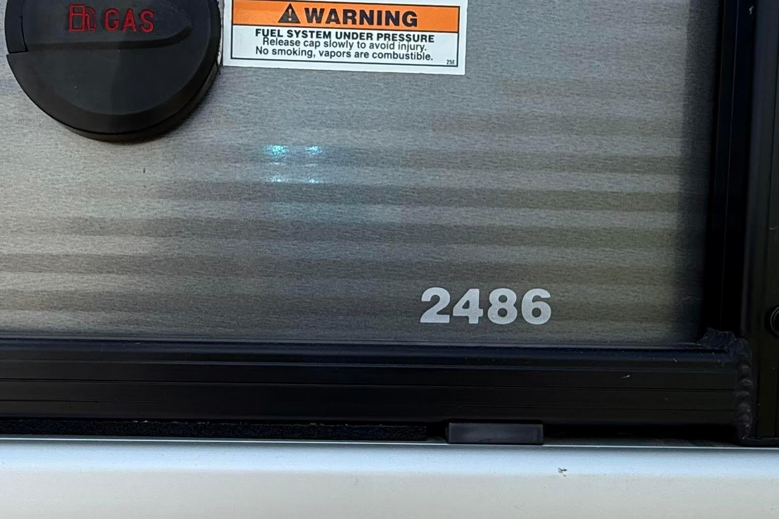 Close-up of 2022 Godfrey SWEETWATER 2486 fuel cap and warning label.