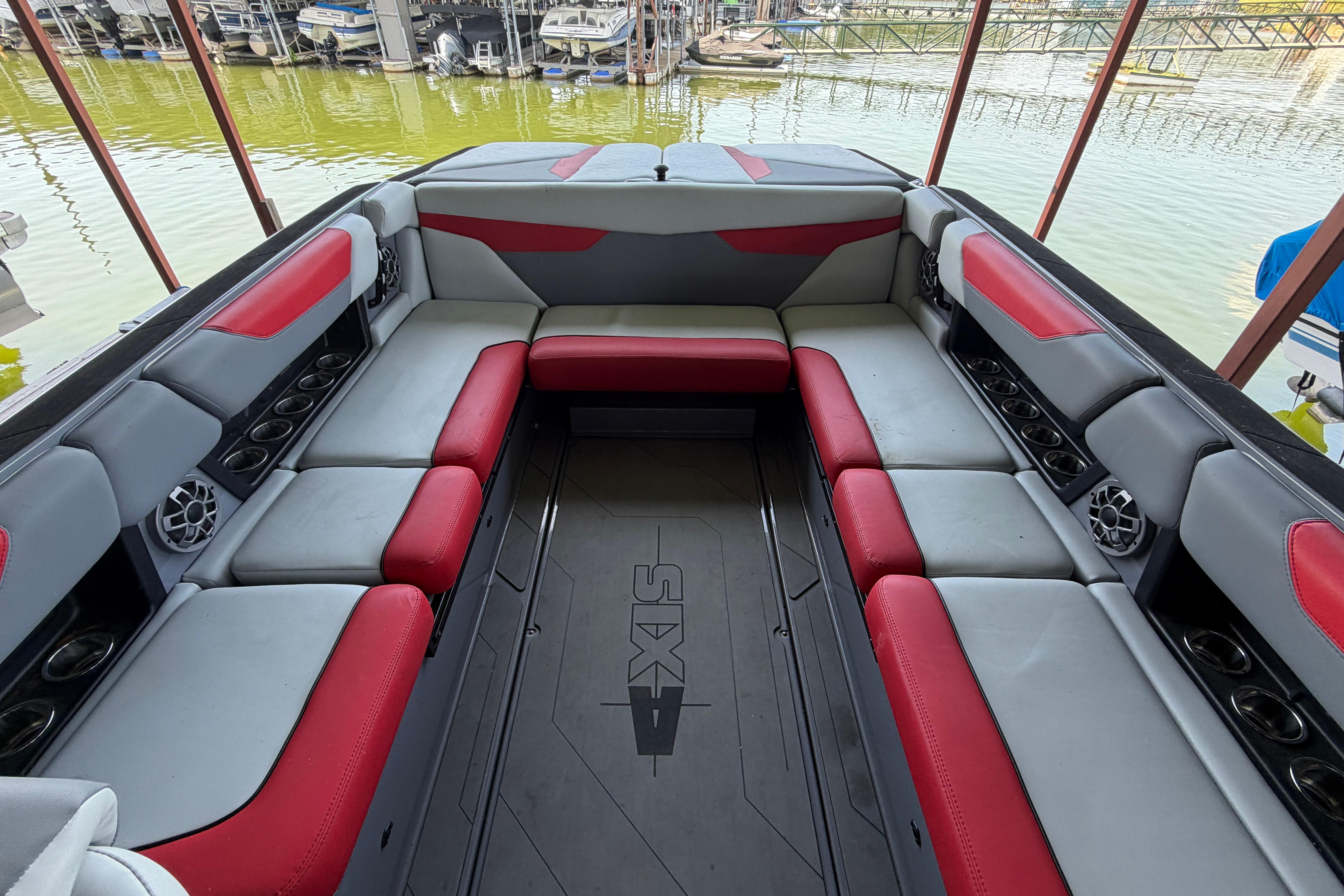 2021 Axis A24 boat interior with red and gray seating, docked at marina.