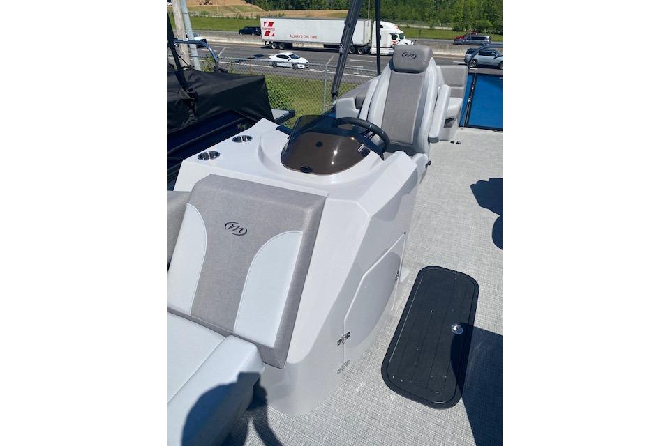 2026 Manitou 23 AURORA RF VPII 575 boat interior with steering console and seating.