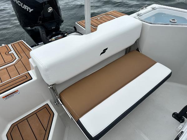 2025 Starcraft SVX 211 OB CC boat interior with cushioned seating and Mercury outboard motor.