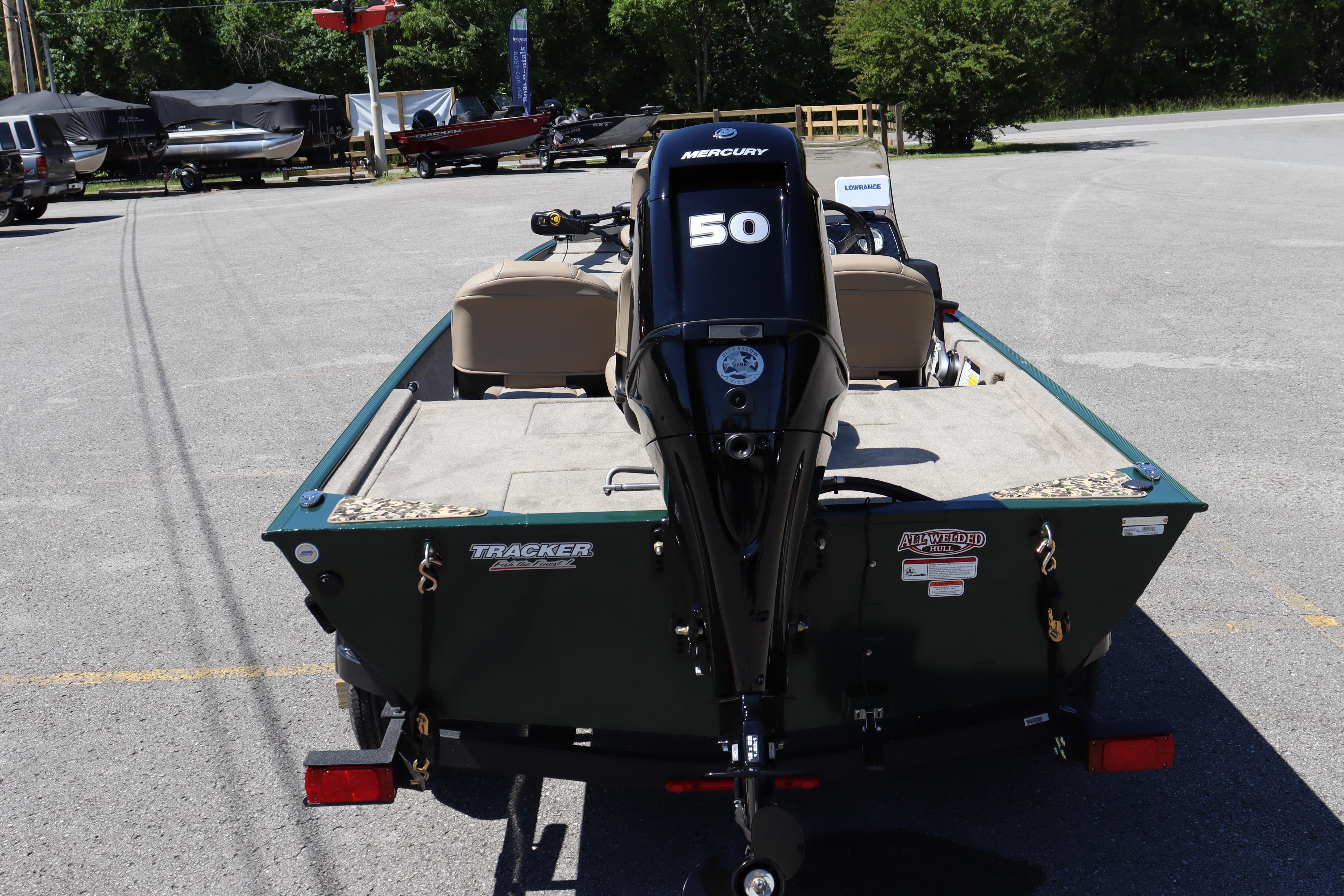 2026 Tracker Bass Tracker Classic Limited boat with Mercury 50 engine in parking lot.