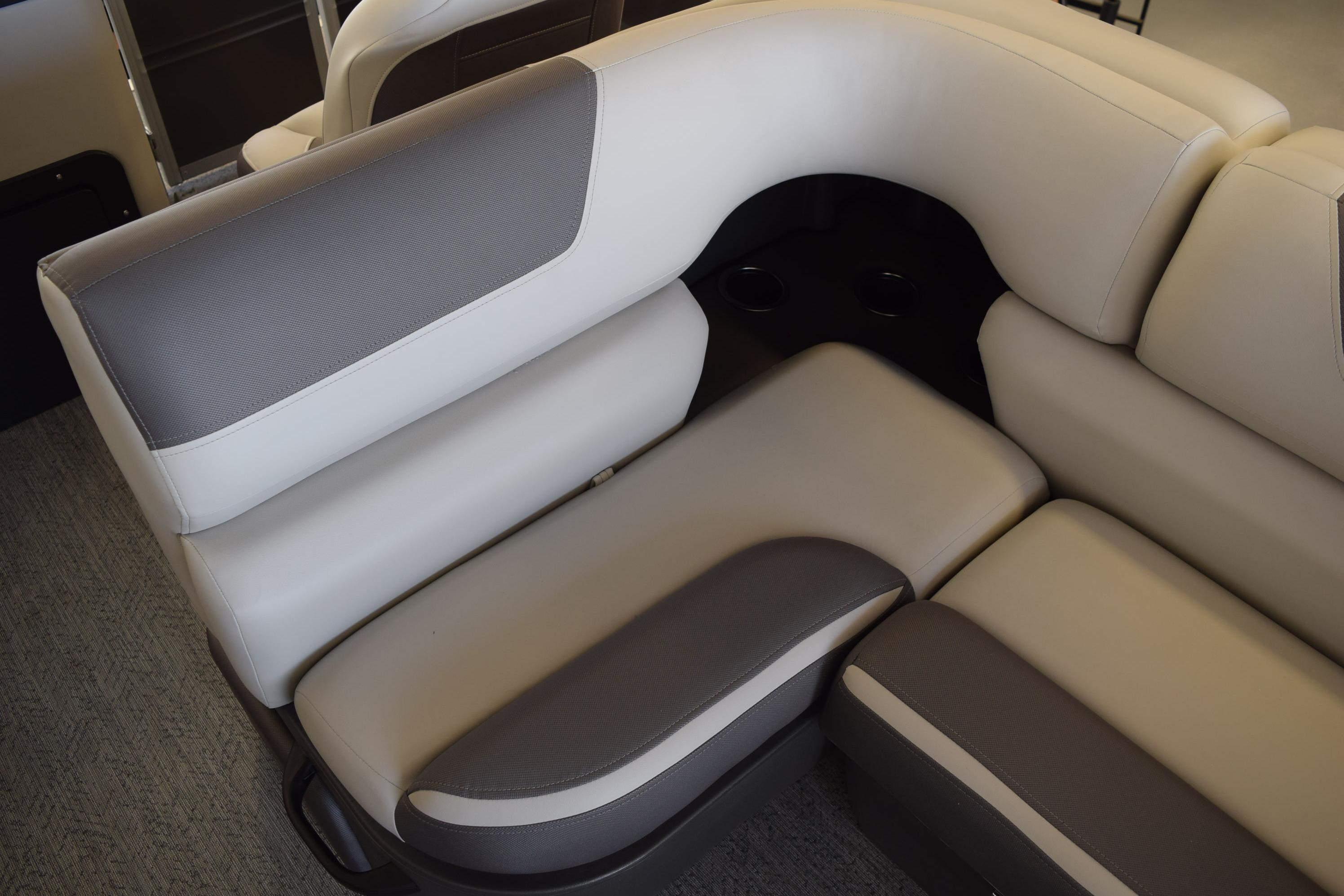 2026 Sun Tracker Fishin' Barge 22 DLX interior seating, featuring beige and gray upholstery.