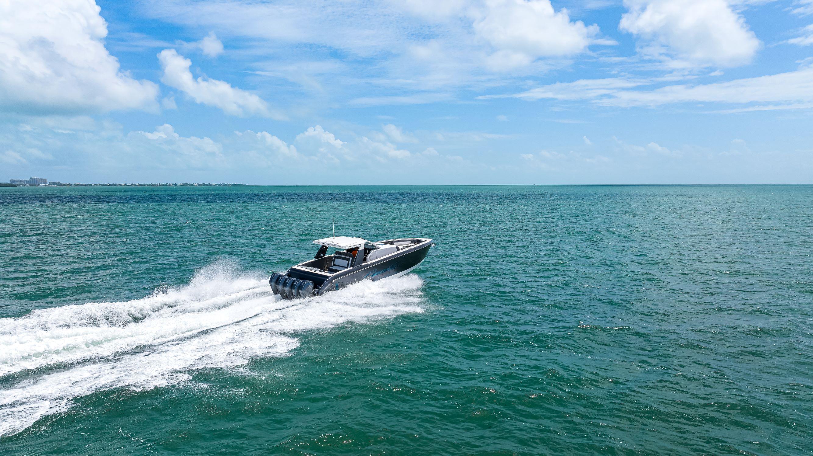 2022 Cigarette 42 Auroris speedboat cruising on open ocean under blue sky.