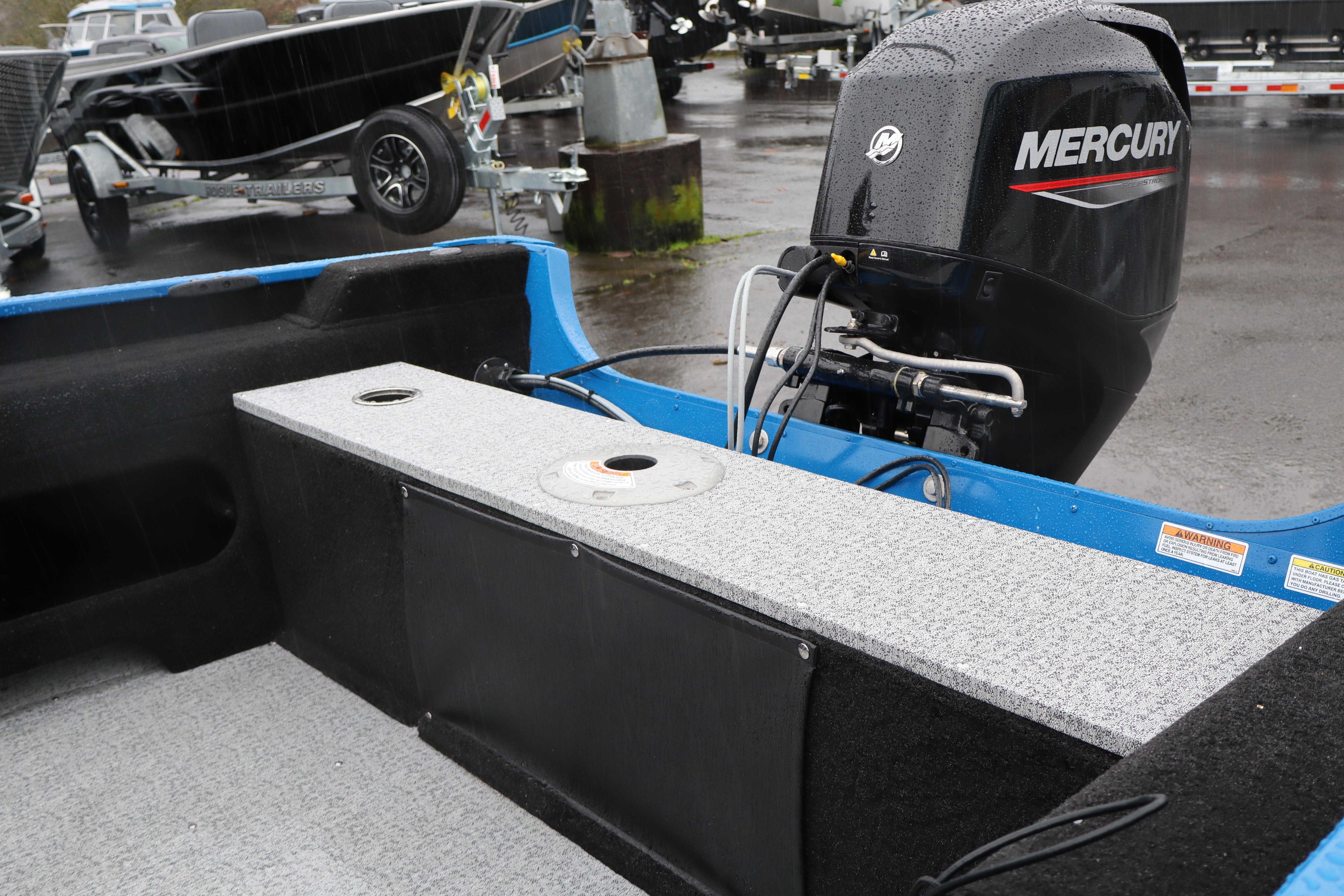 2026 Smoker Craft Lazer 161 boat with Mercury outboard motor in a parking lot.