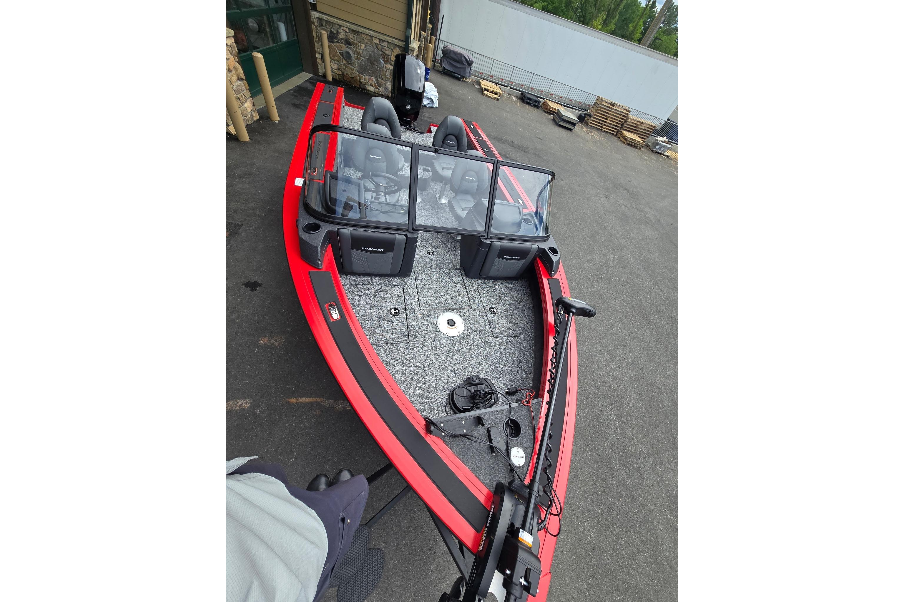 2026 Tracker Targa V-18 WT boat with red trim, parked on pavement.