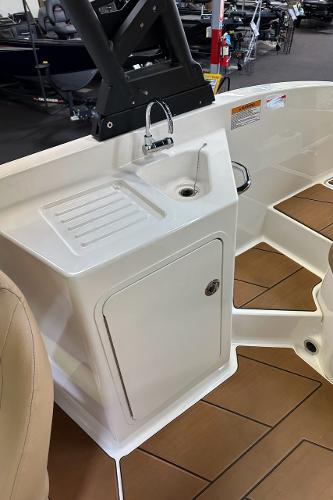 2024 Bayliner DX 2250 boat interior with sink and storage compartment.