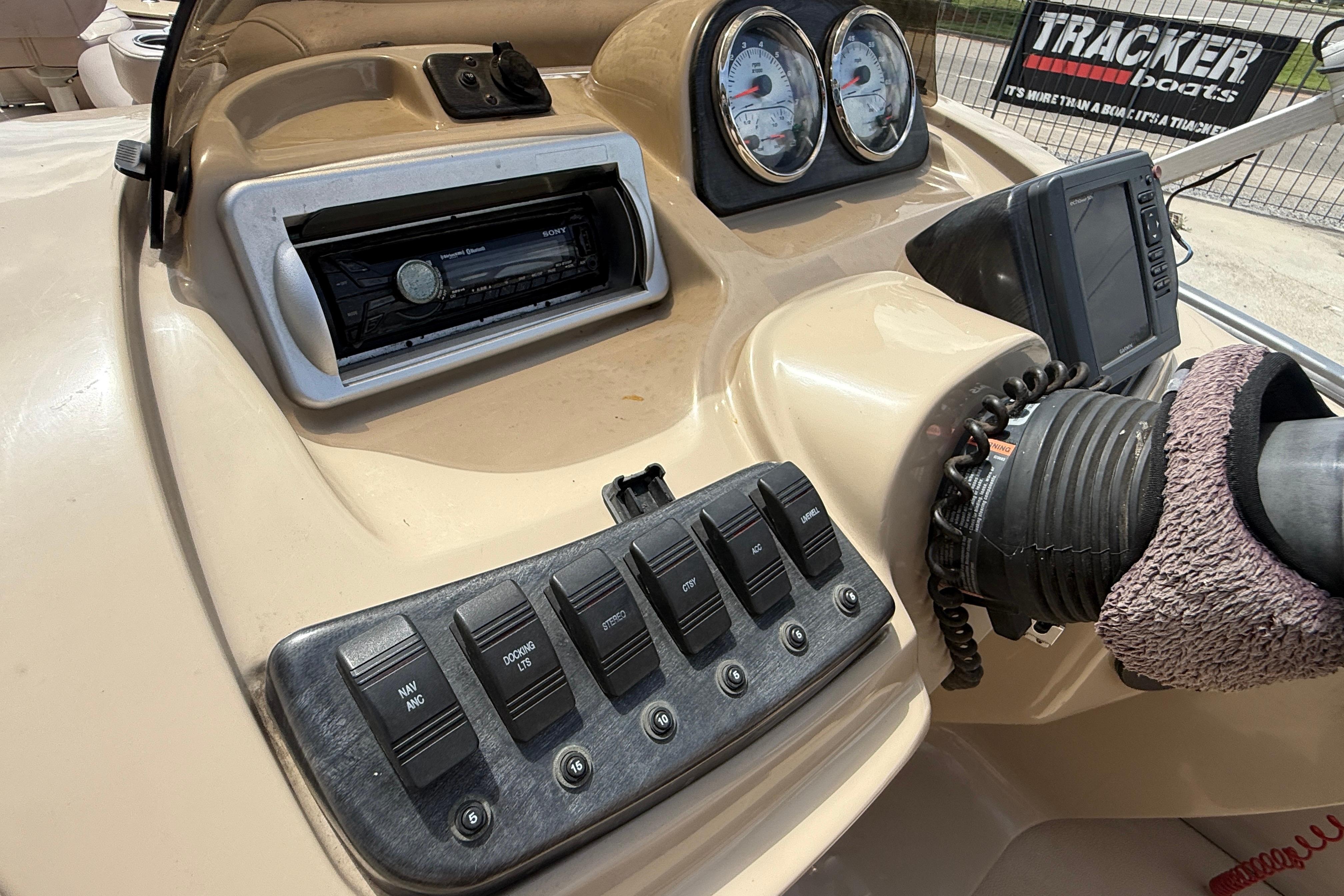 Control panel of a 2014 Godfrey Sweetwater 2486 C boat with gauges and switches.