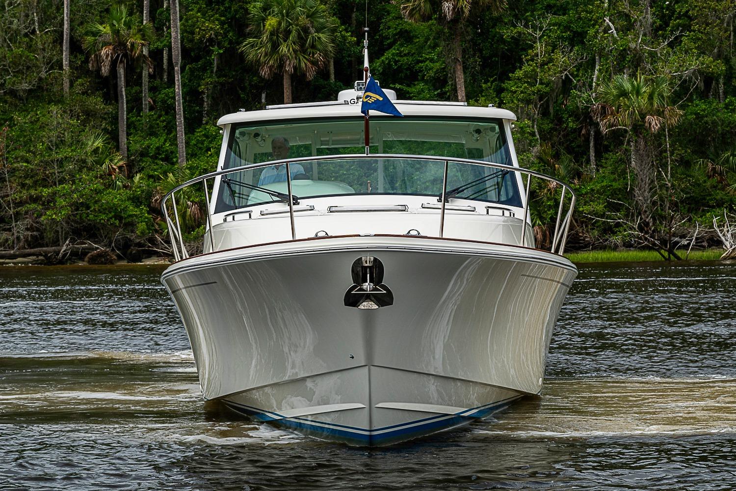 Front view of 2023 Hinckley Sport Boat 40 X cruising on a river.