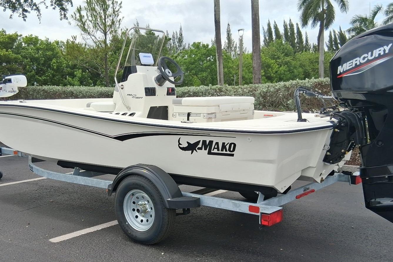 2026 Mako Pro Skiff 15 CC boat on trailer with Mercury outboard motor.