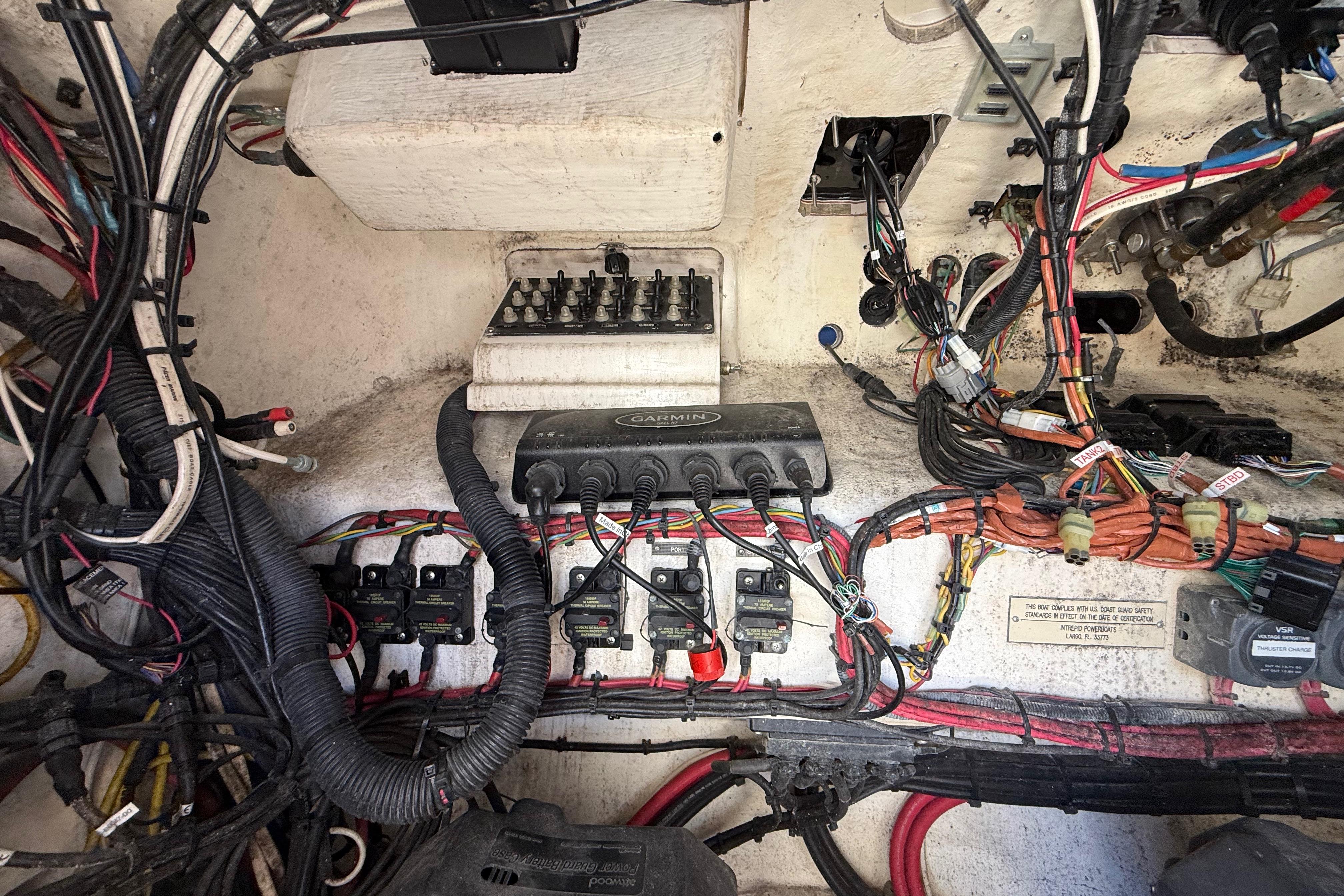 Electrical wiring and components inside a 2008 Intrepid 377 Walkaround boat.