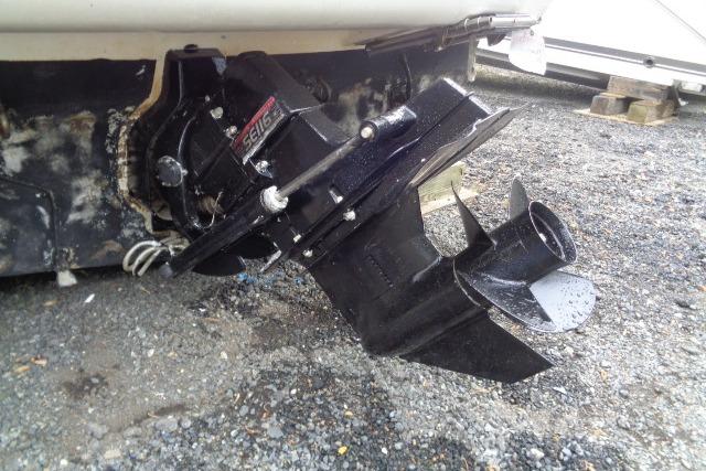 Bayliner 2455 Ciera Sunbridge 2000 boat stern drive on gravel surface.