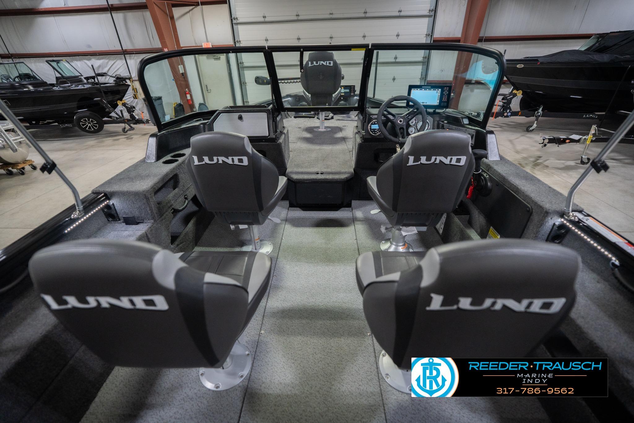2026 Lund 2075 Impact XS boat interior with four seats in a showroom.