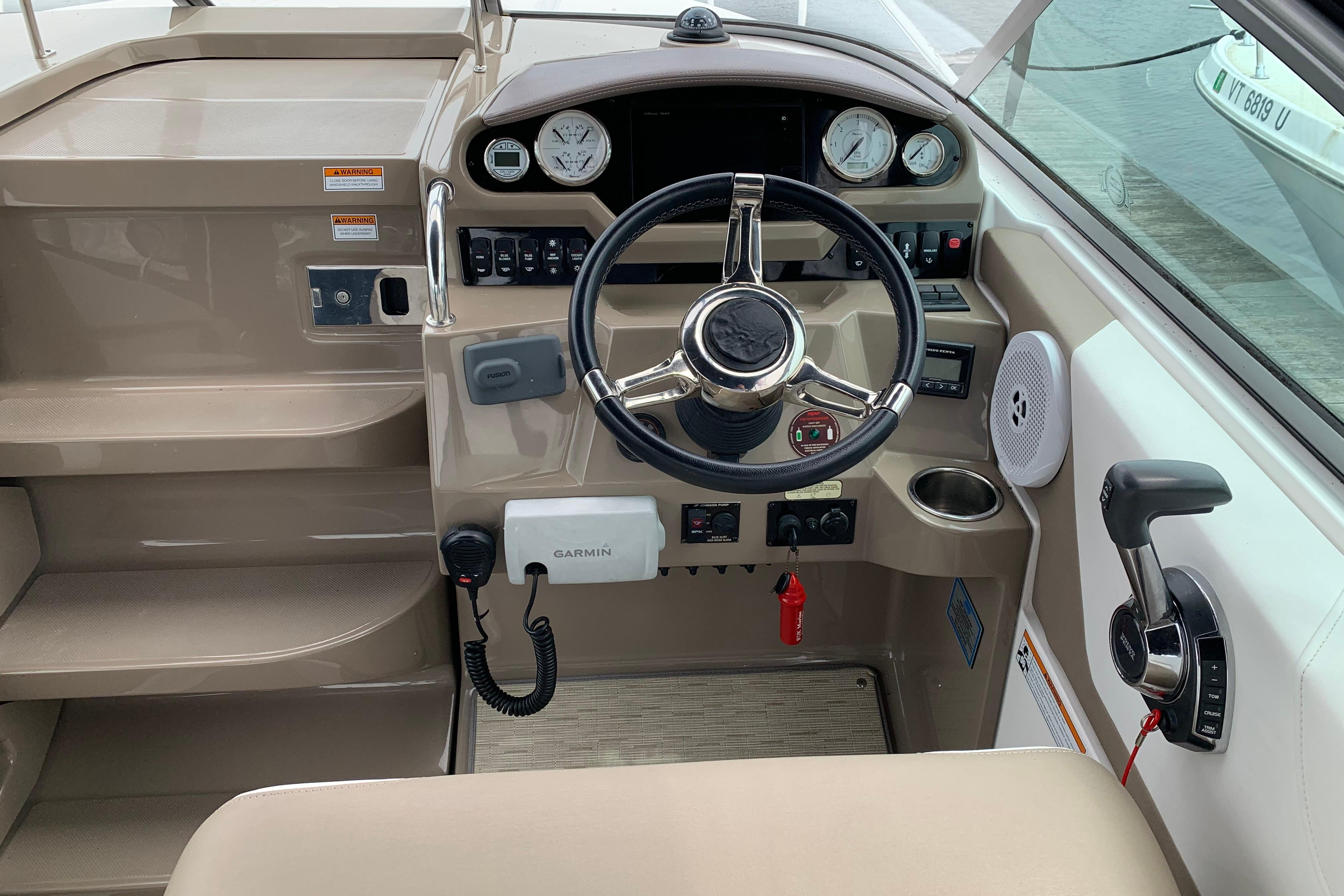Cockpit of 2017 Regal 26 Express boat with steering wheel and control panel.