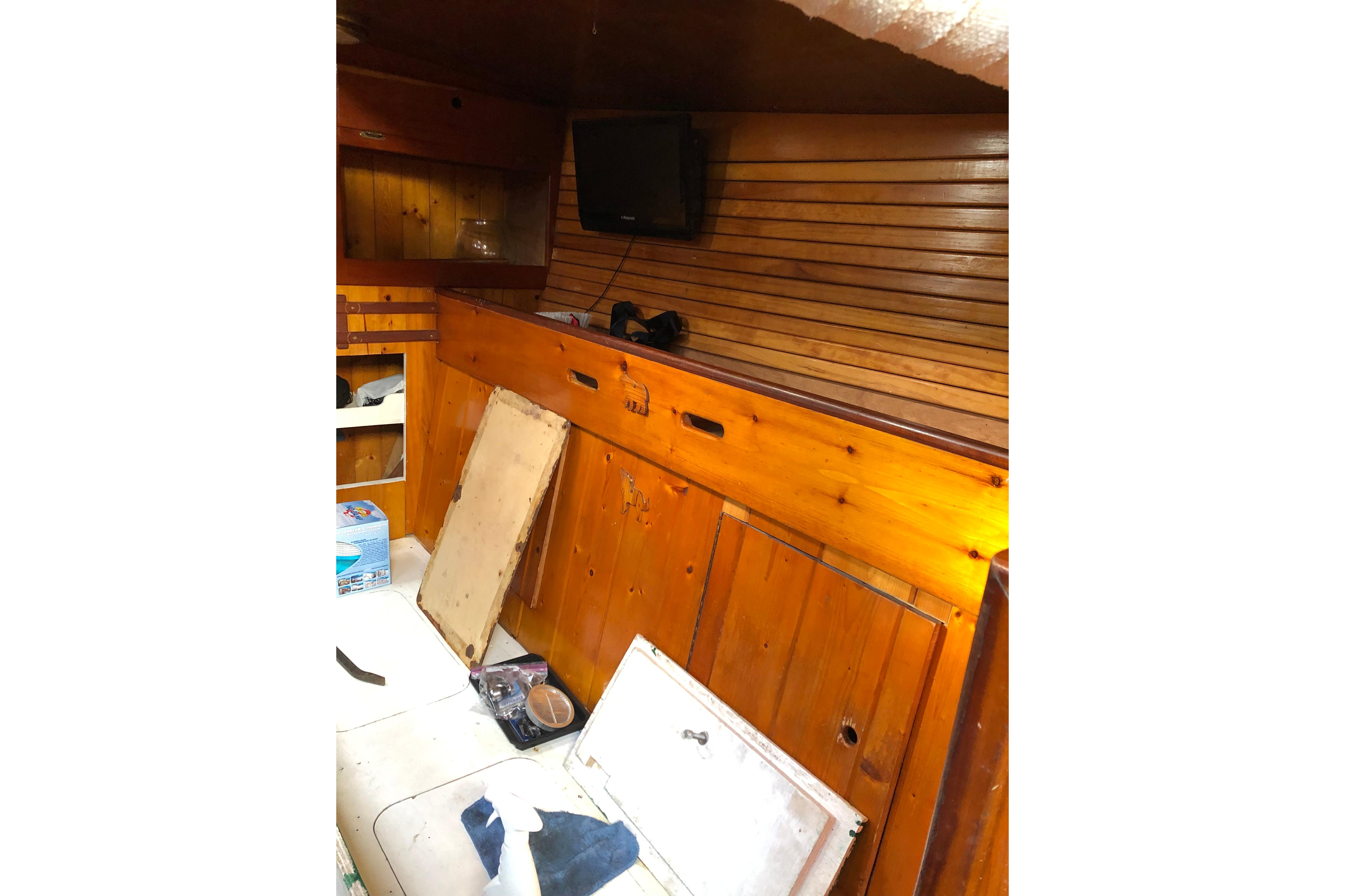 Interior of 1992 Treworgy 65 Schooner with wooden paneling and storage compartments.