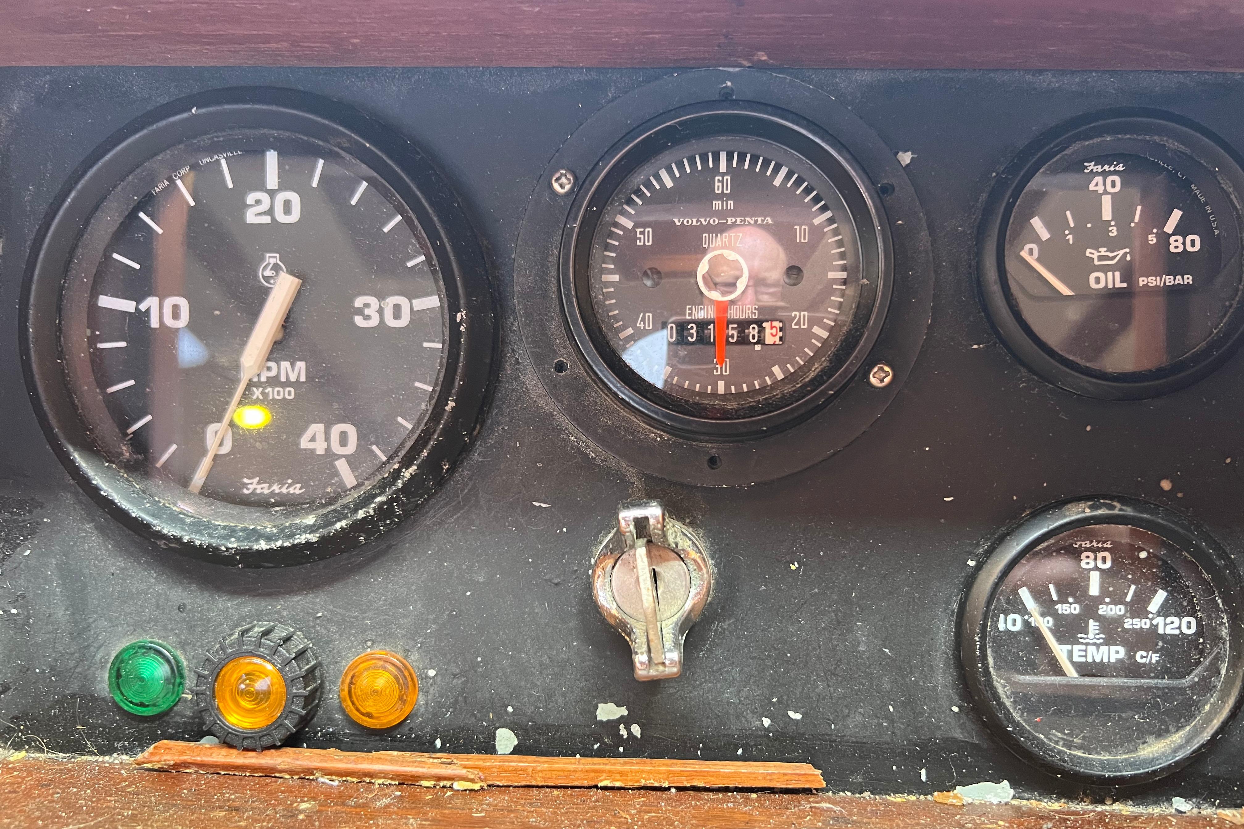 Instrument panel of a 1996 Bruce Roberts Cutter with RPM, engine hours, oil, and temperature gauges.