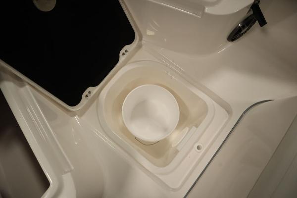 2025 Sea Fox 228 Commander boat storage compartment with white bucket.