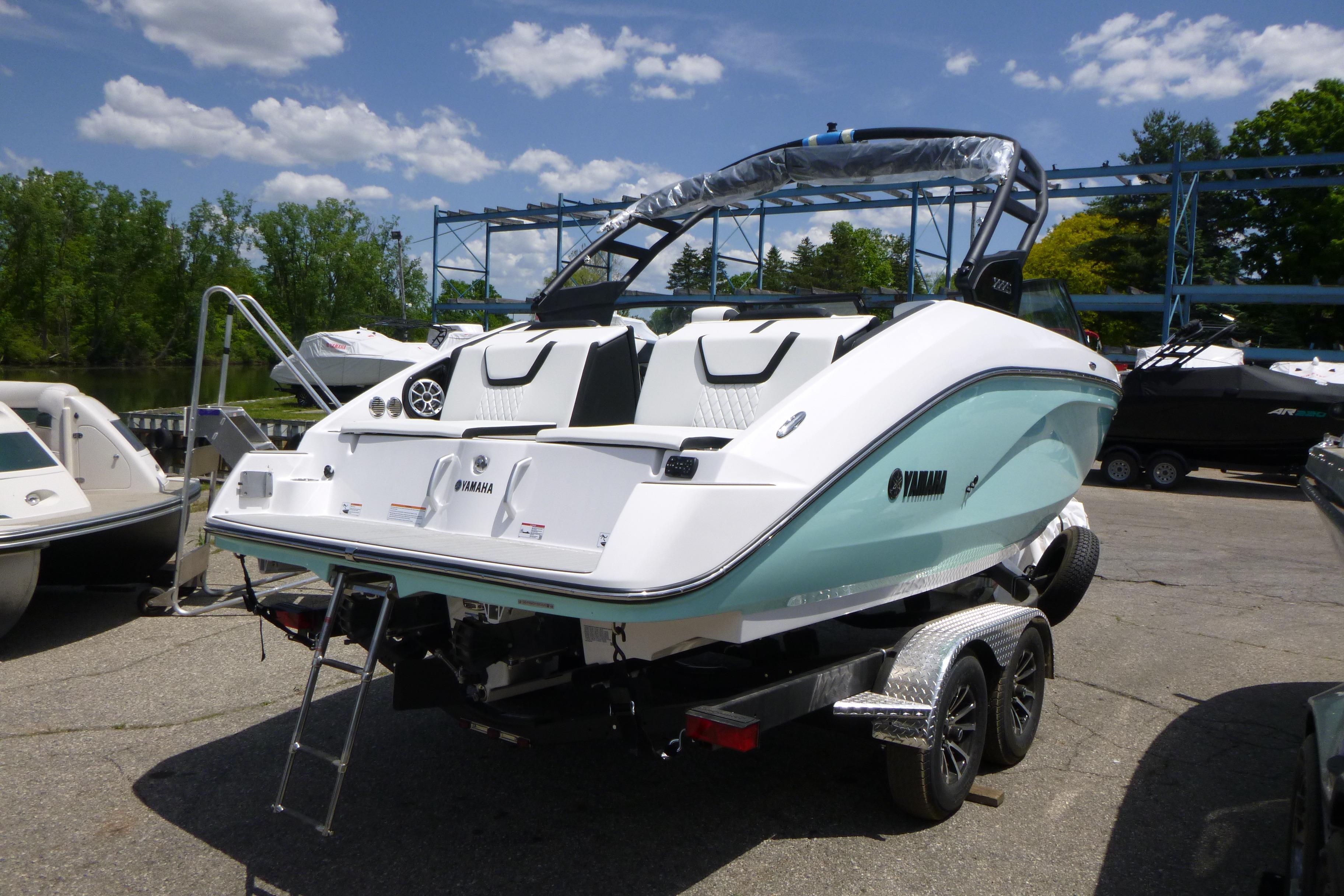 2026 Yamaha Boats 222S on trailer, parked outdoors under a clear blue sky.