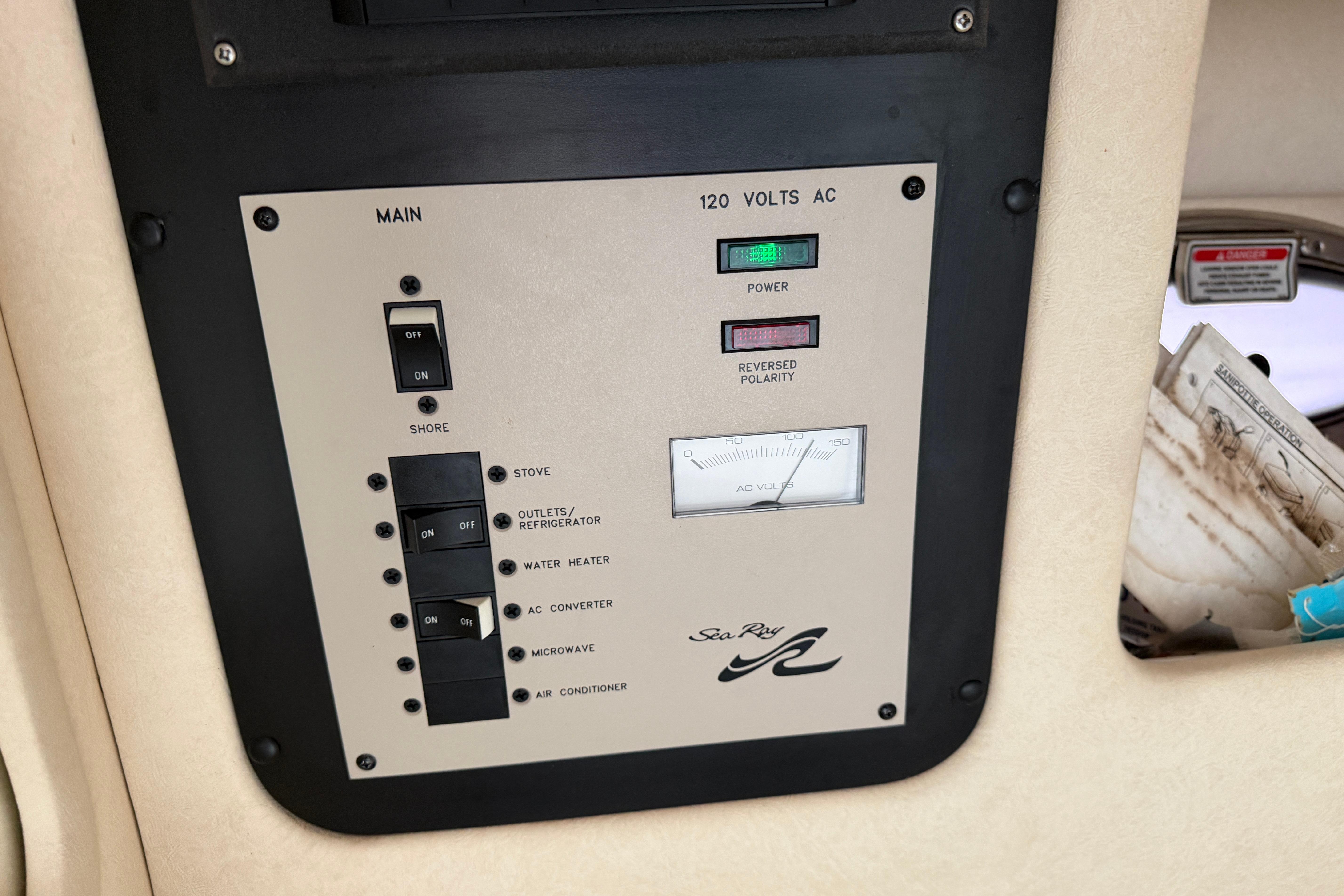 Control panel of a 2003 Sea Ray 290 Bowrider boat, showing electrical switches and indicators.
