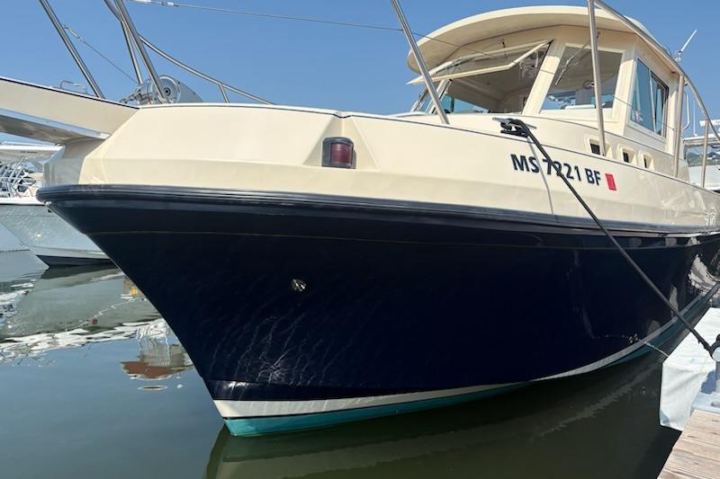 2003 Albin 28 Tournament Express boat docked in marina, side view.