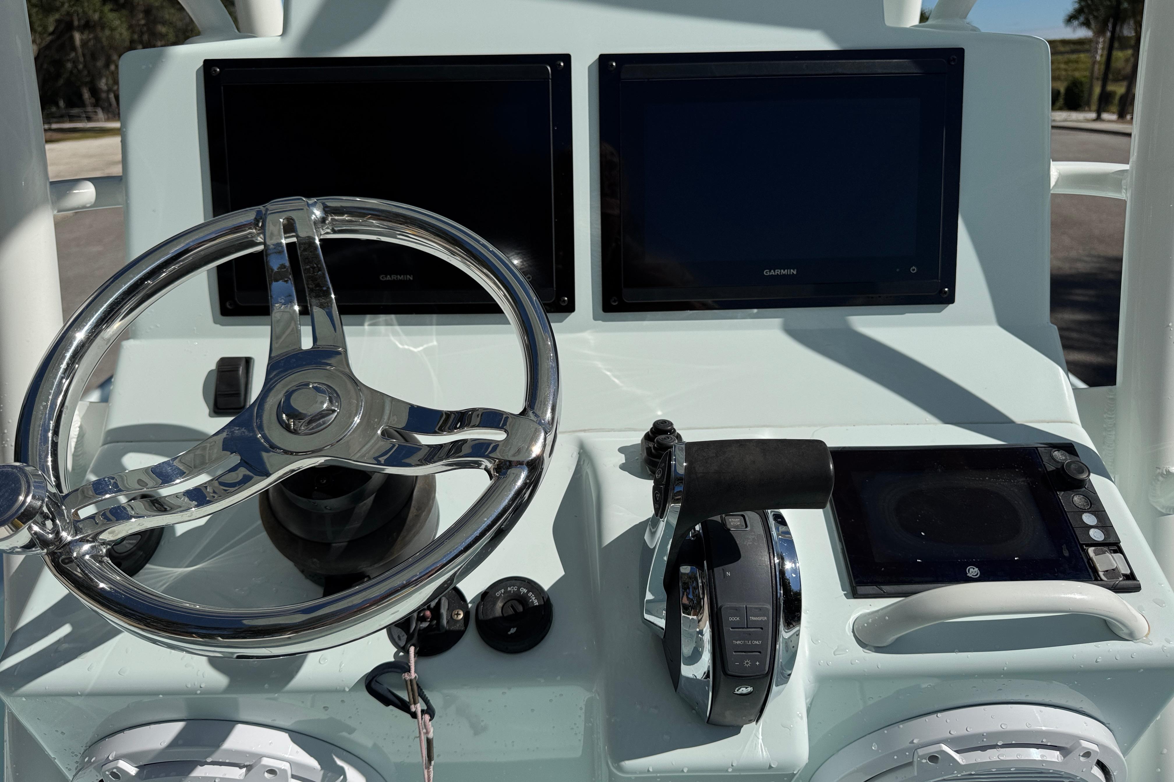 2017 Yellowfin 24 Bay CE boat dashboard with dual Garmin screens and steering wheel.