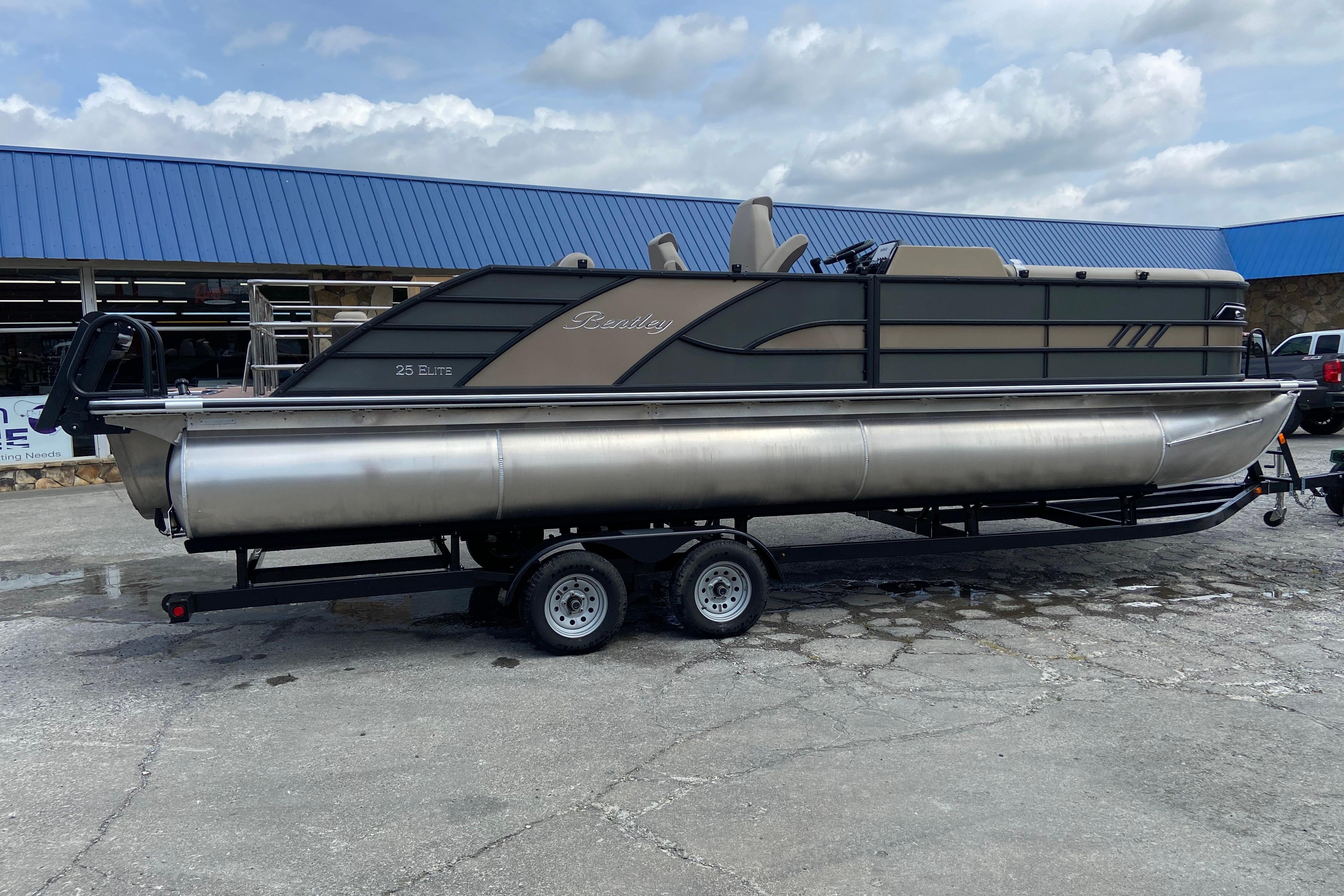 2026 Bentley Pontoons 25 Elite Swingback on trailer, side view.