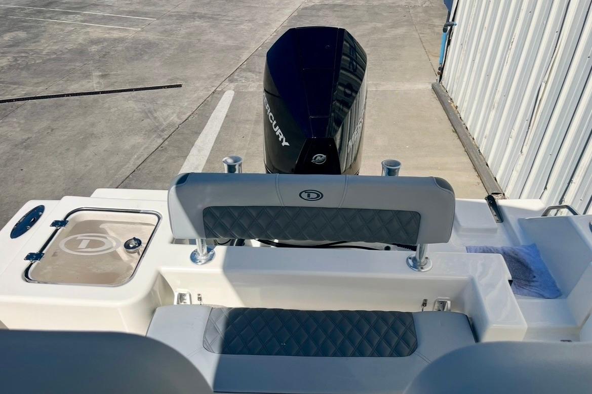 2025 Defiance Catalina 240 boat stern with Mercury outboard motor and seating.
