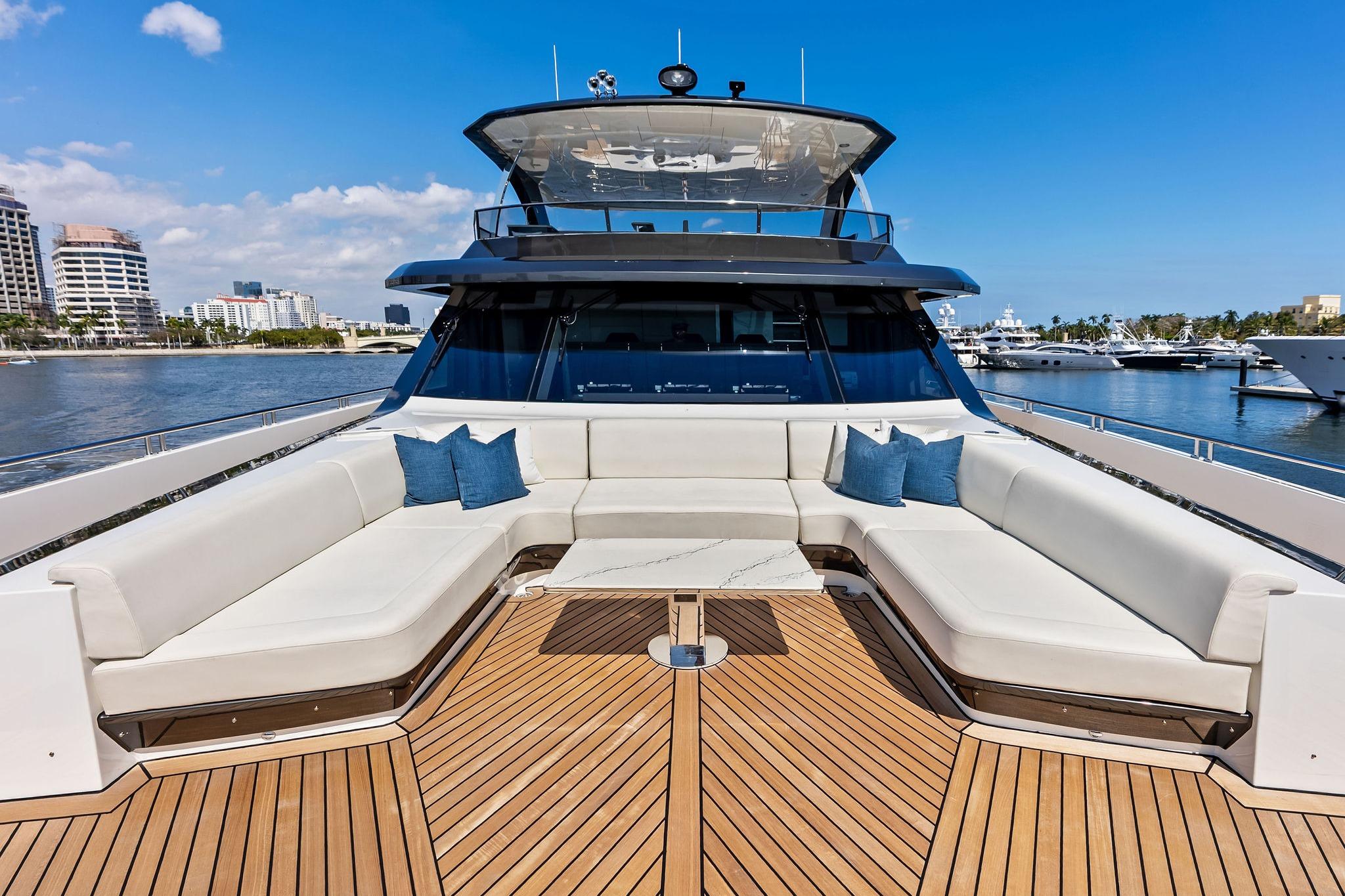 Luxurious 2024 Ocean Alexander 35 Revolution yacht with spacious deck seating and scenic marina view.