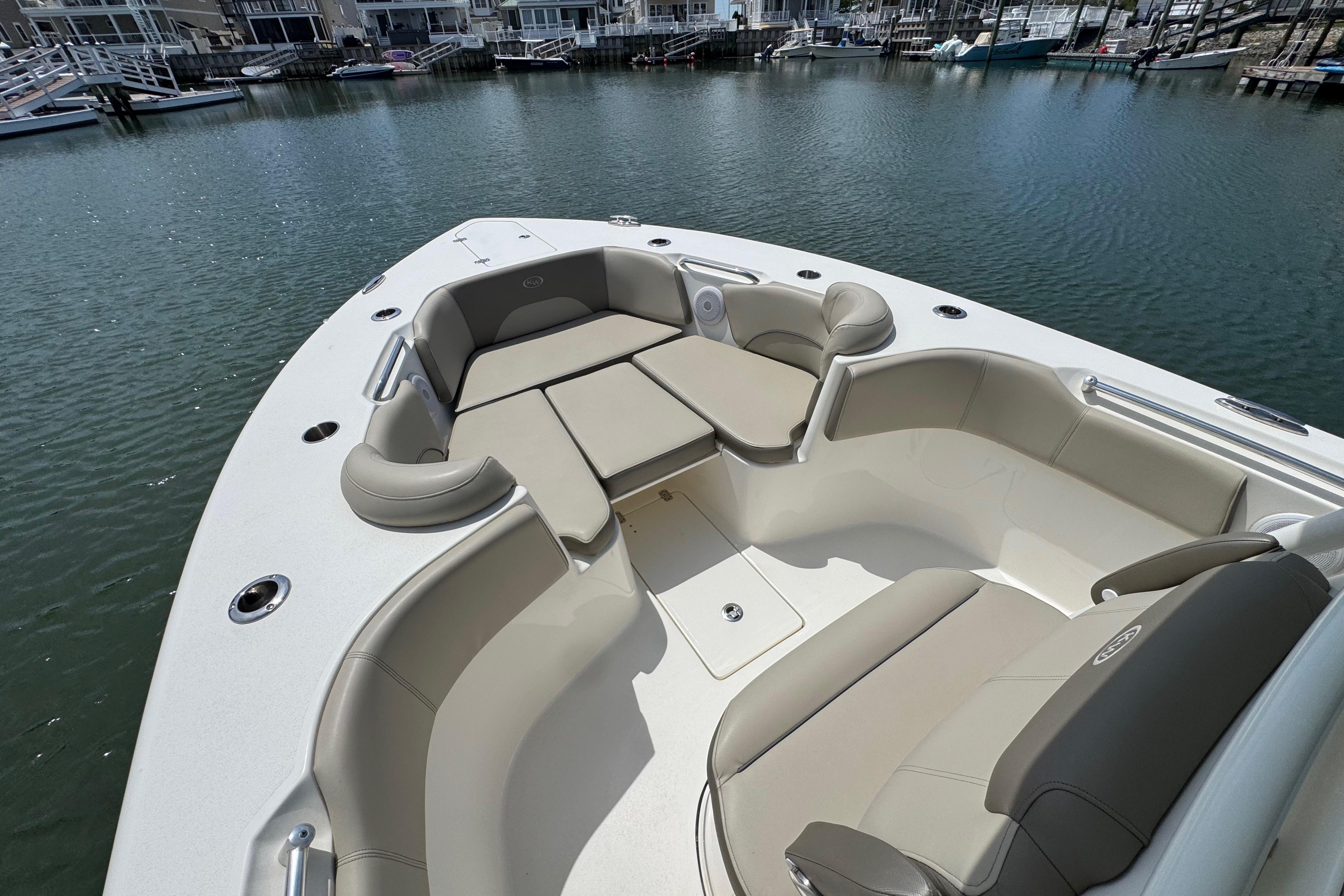 2022 Key West 263 FS boat with spacious seating in a marina setting.