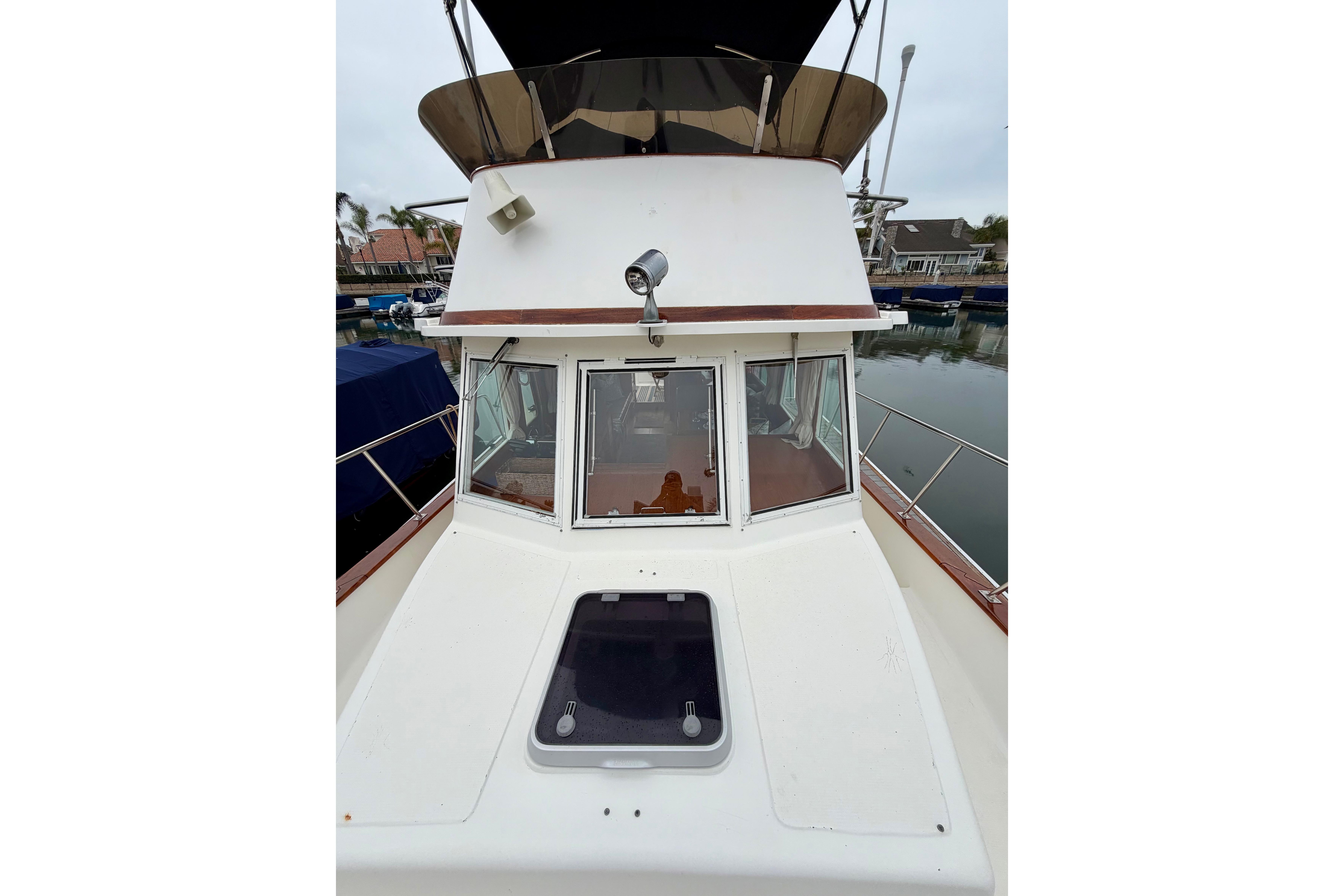 2001 Mariner Orient Europa boat docked, featuring a spacious deck and cabin windows.