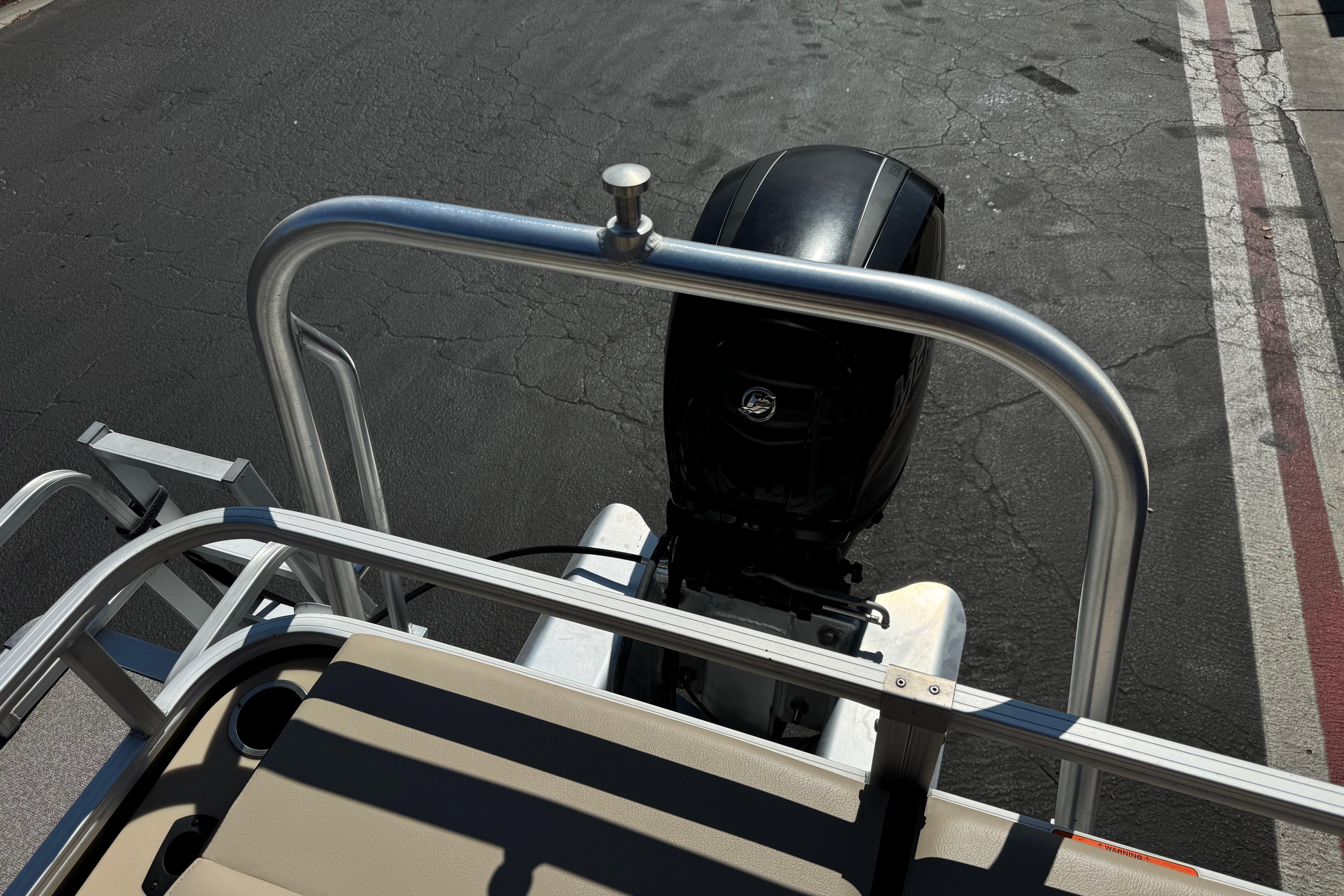 2018 Sun Tracker SportFish 22 DLX boat with outboard motor, viewed from rear deck.
