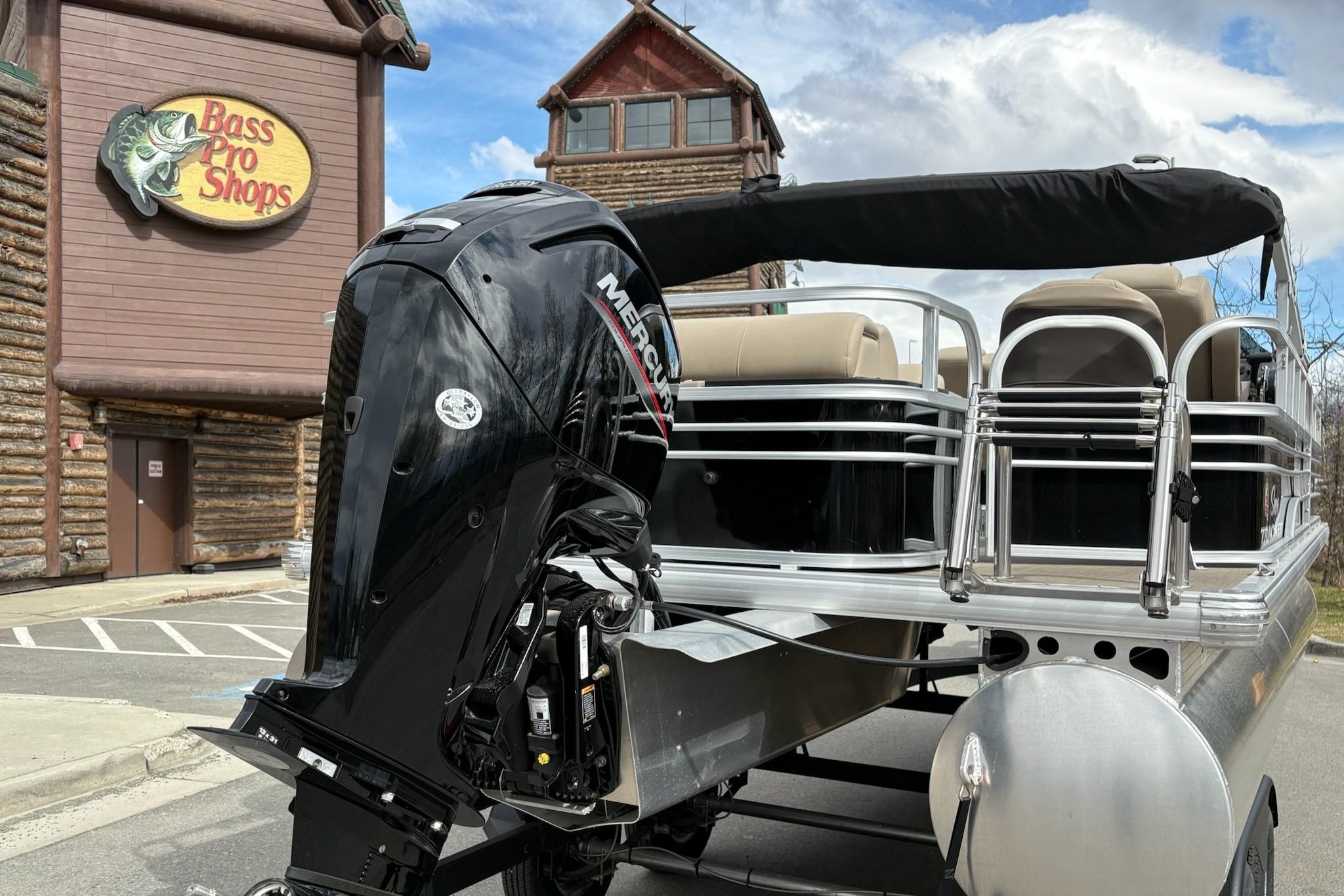 2023 Sun Tracker SportFish 20 DLX pontoon boat outside Bass Pro Shops.