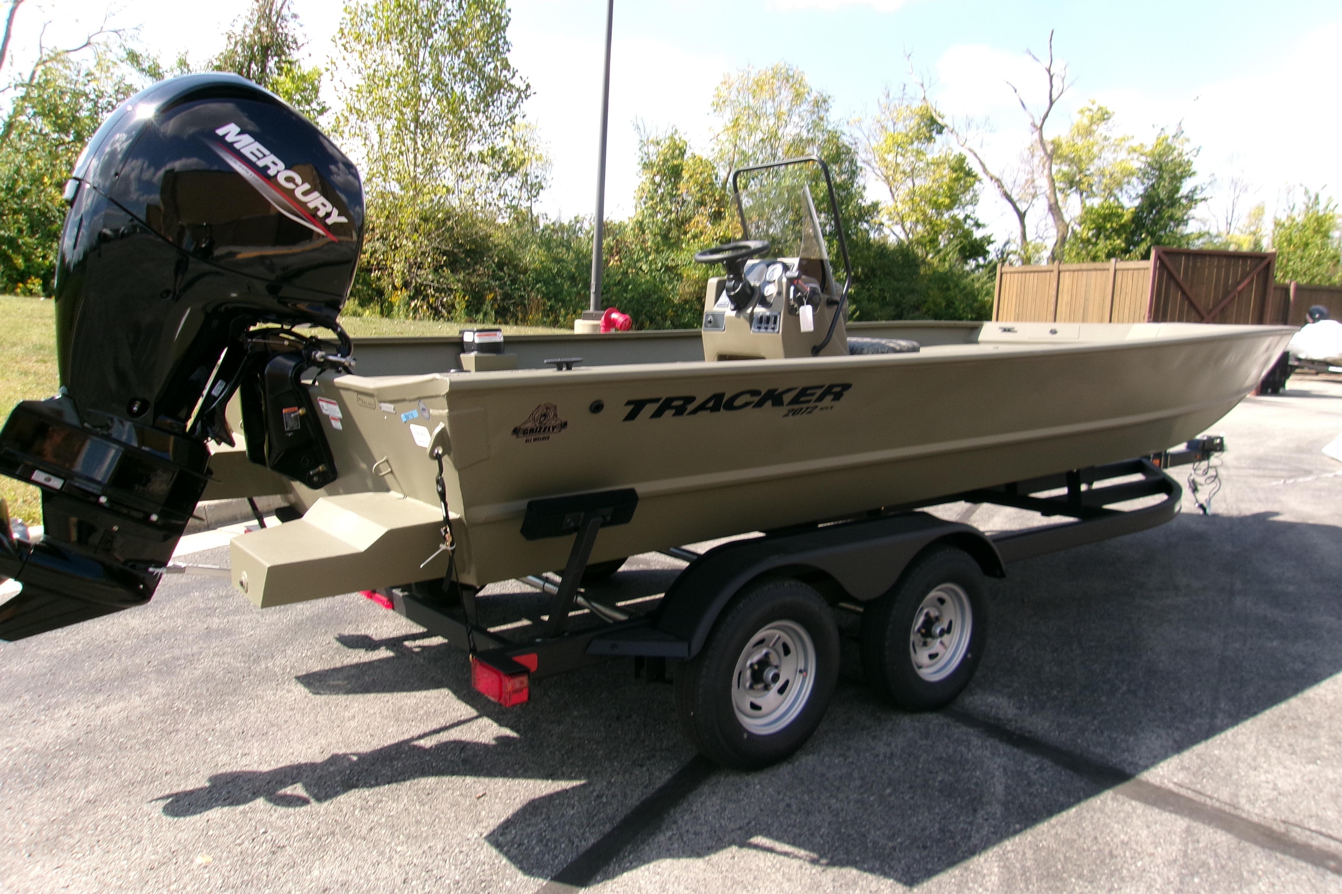 2026 Tracker Grizzly 2072 CC boat on trailer with Mercury outboard motor.