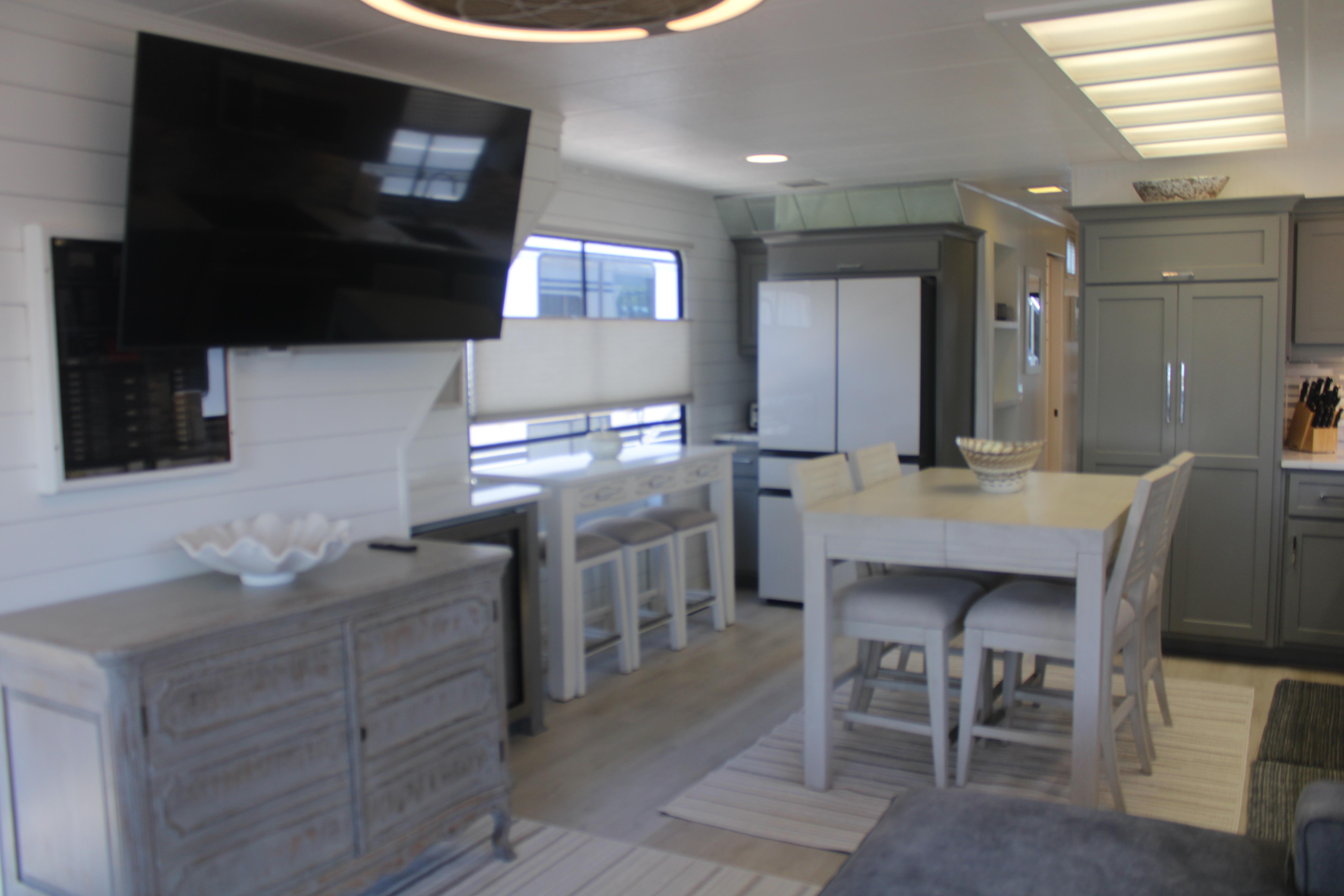 Modern interior of a 1992 Sumerset 66 houseboat with dining area and kitchen.