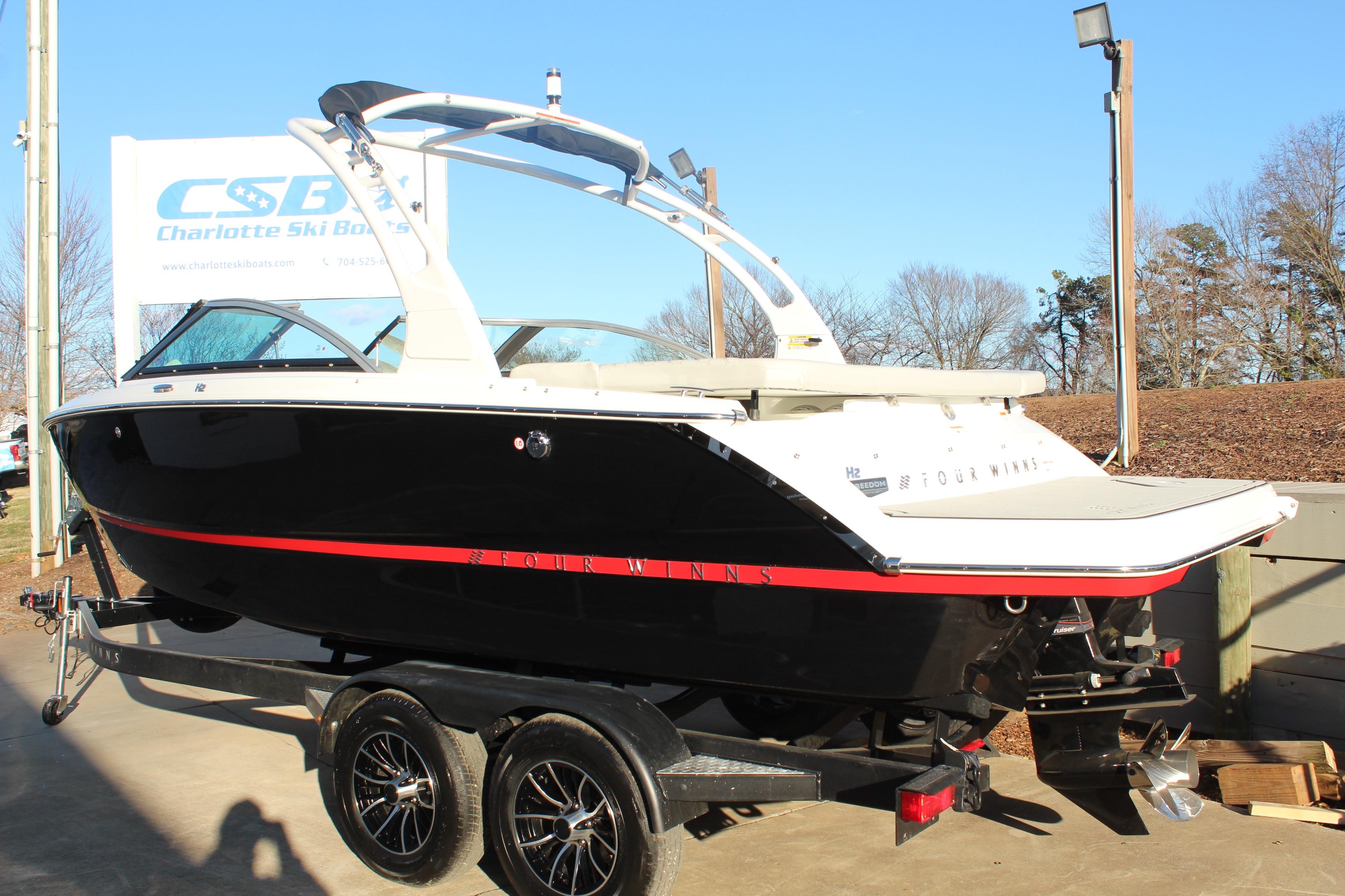2026 Four Winns H2 Freedom boat on trailer at Charlotte Ski Boats dealership.