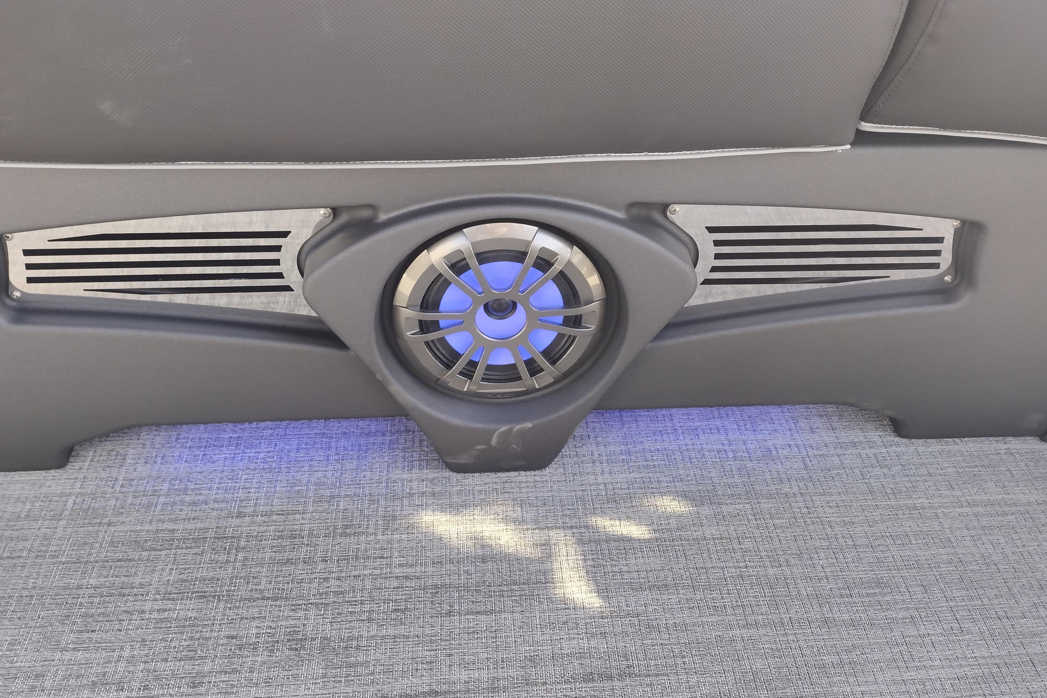 2026 Tahoe Pontoon 23 LTZ Quad Lounge speaker with blue LED lighting on gray flooring.
