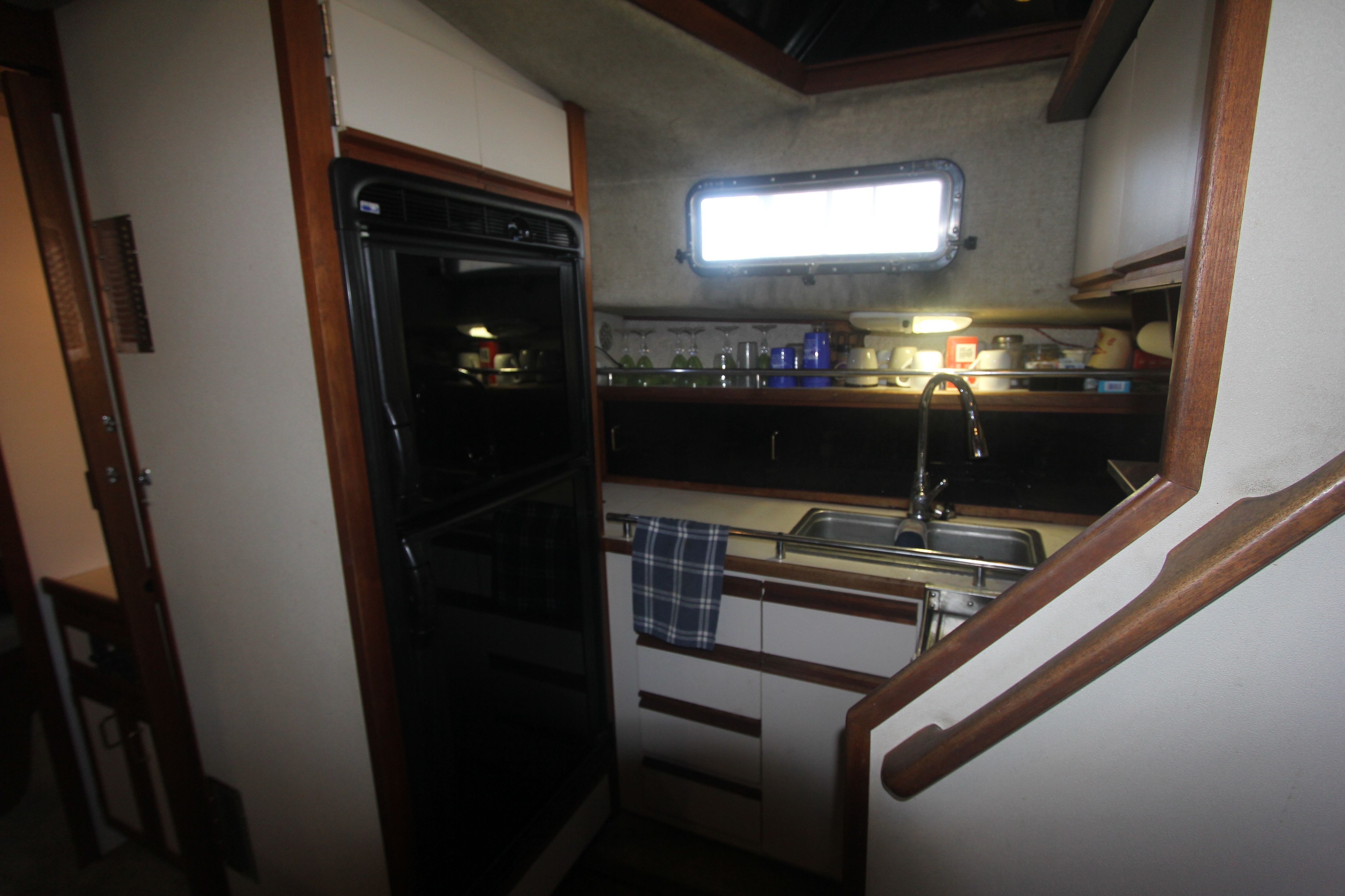 Galley in a 1988 Carver 3607 Aft Cabin Motor Yacht with sink and cabinets.