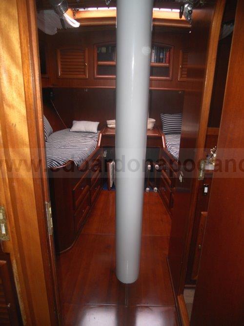 Interior of 1984 Carlini Sciarrelli 20 schooner with wooden finishes and twin beds.