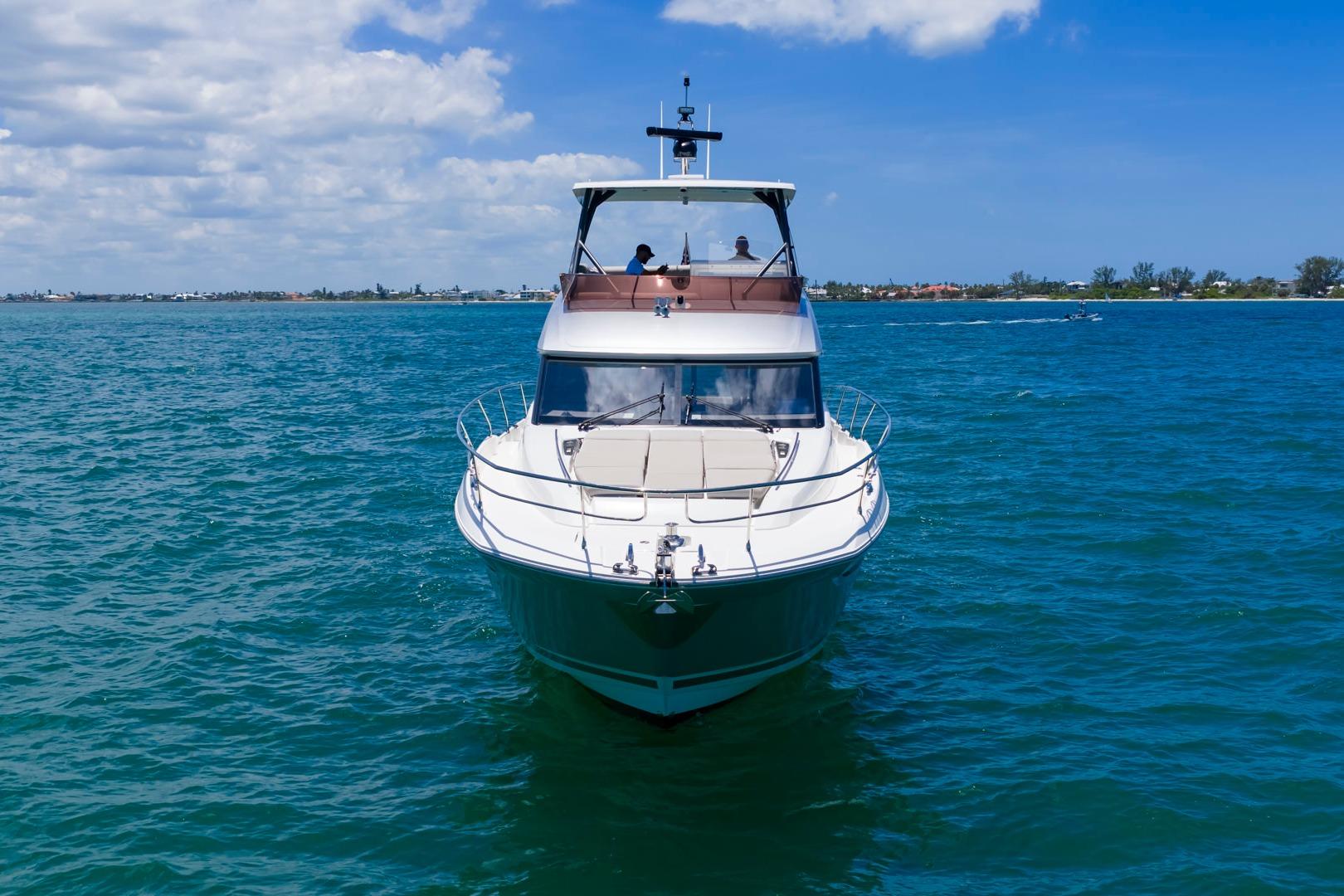 2022 Prestige 520 yacht cruising on clear blue waters under a sunny sky.