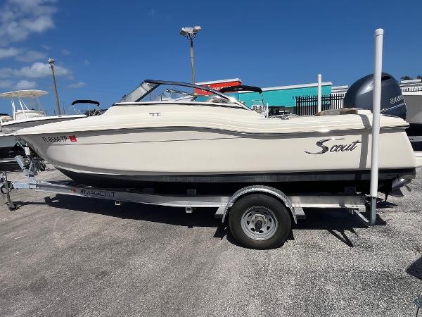 2018 Scout 210 Dorado boat on trailer under clear blue sky.