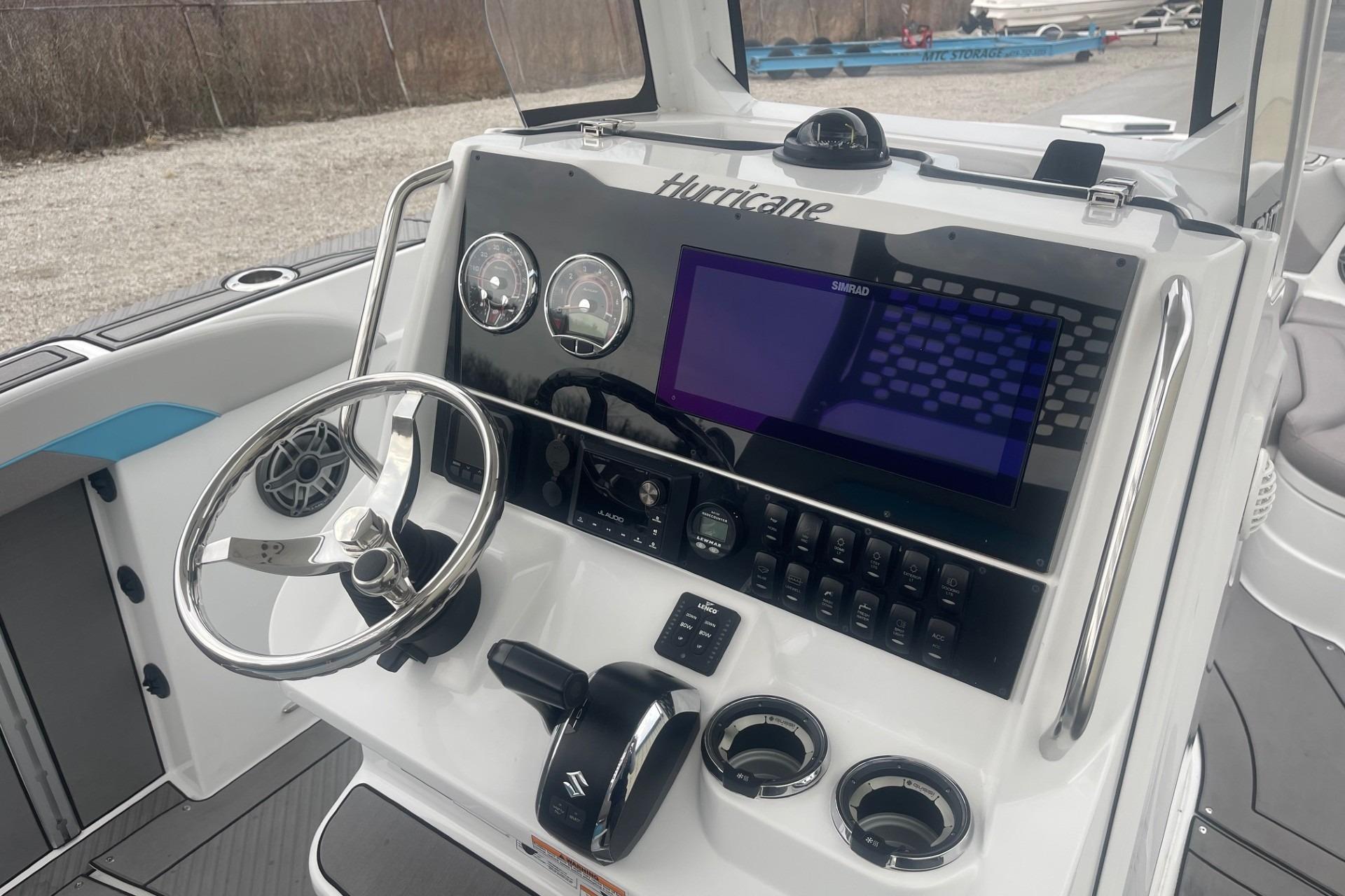2025 Hurricane Center Console 24 OB boat dashboard with steering wheel and navigation controls.