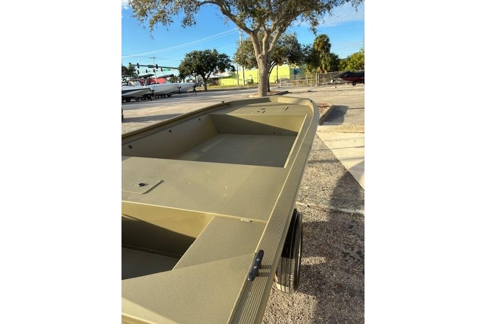 2026 Tracker Grizzly 1648 Utility boat in a parking lot, under a tree.