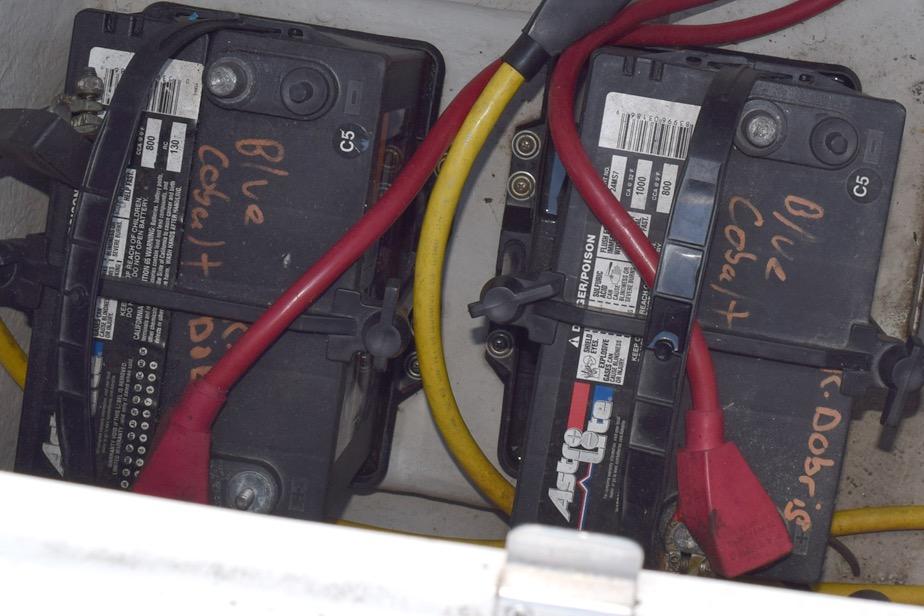 Batteries with red and yellow cables in a 2006 Cobalt 240 boat.