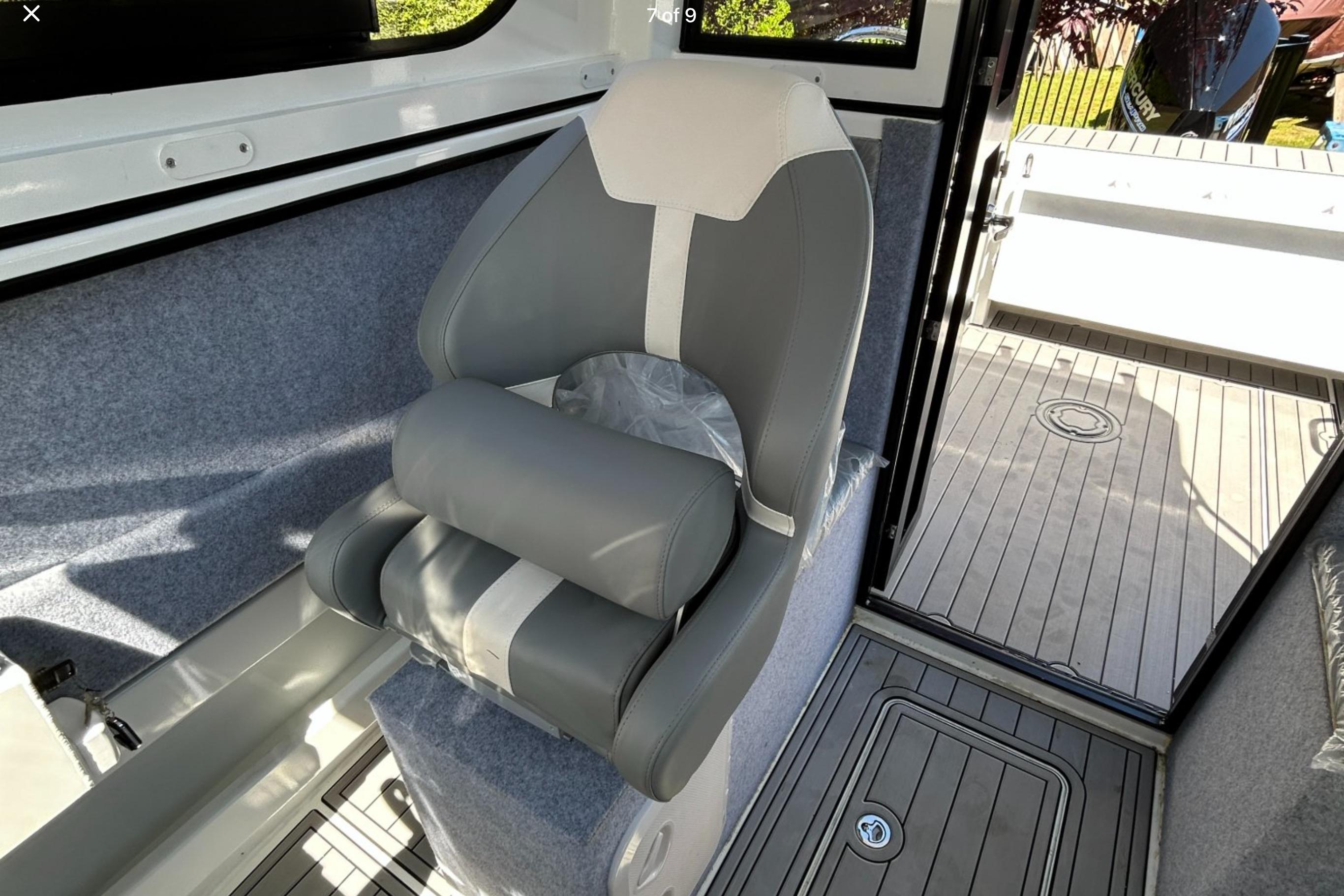 Interior of 2025 Custom Aluminum 7.5 Profisher boat with gray seating and deck.