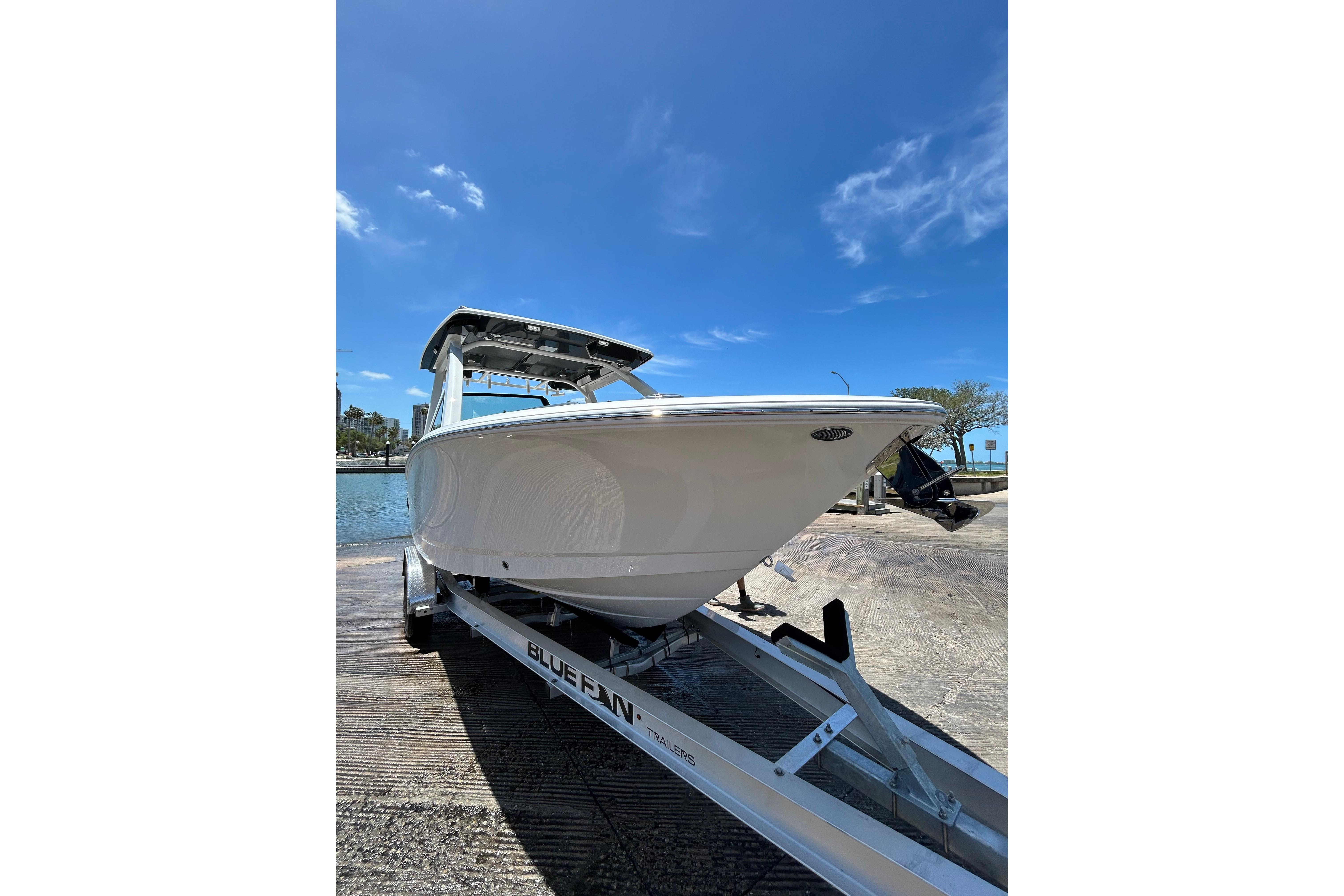 2026 Robalo R257 Dual Console boat on trailer under clear blue sky.