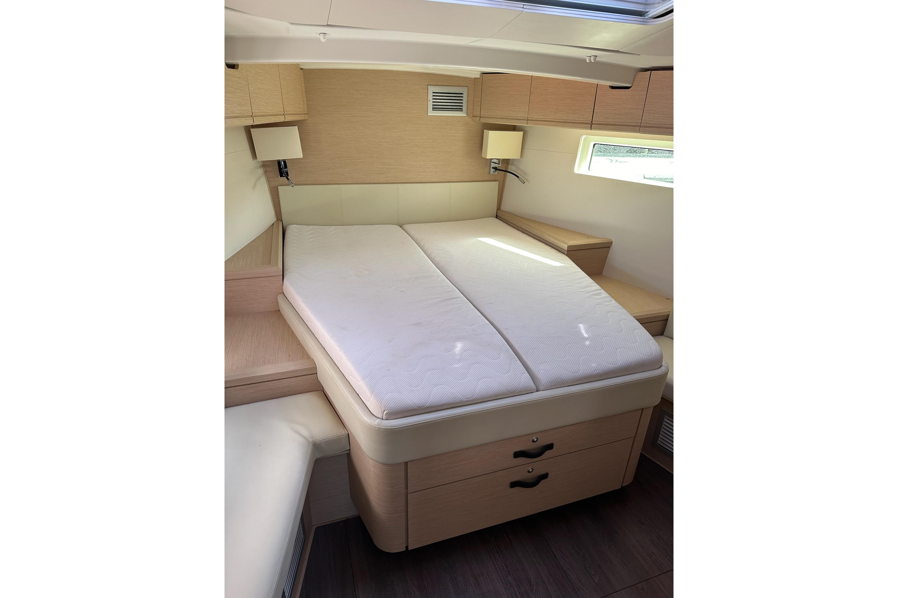Luxurious cabin interior of 2018 Jeanneau 51 yacht with comfortable bed and modern design.