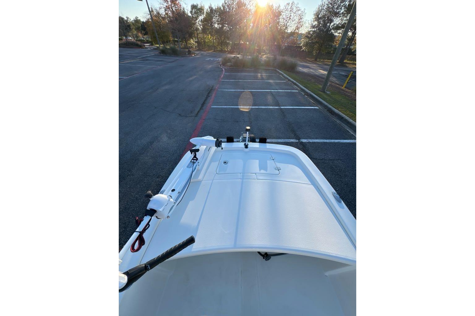 2026 Mako Pro Skiff 13 CC boat parked in a sunlit lot.