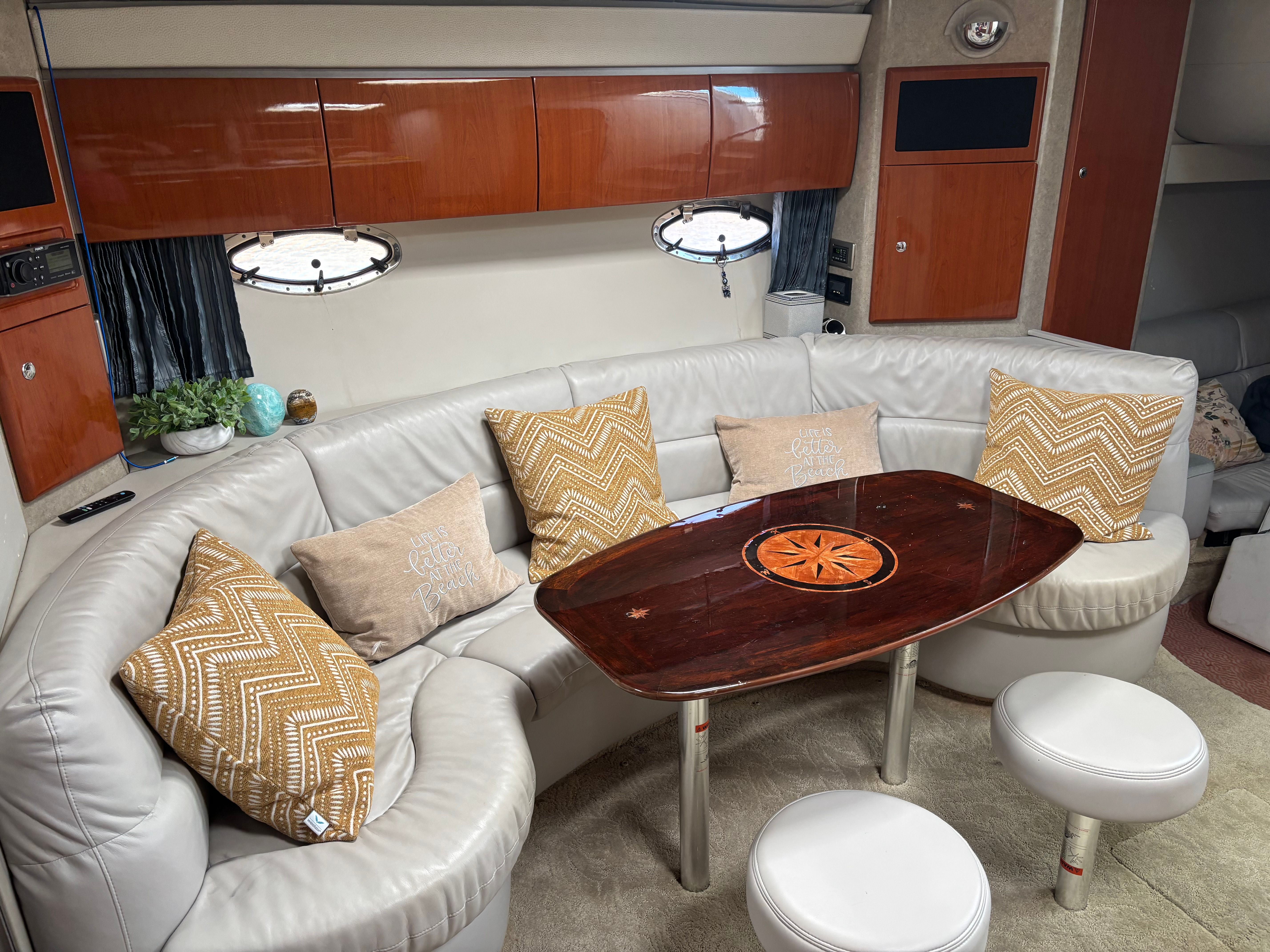 Interior of the 2005 Formula 40 Performance Cruiser with elegant seating area and wooden table.