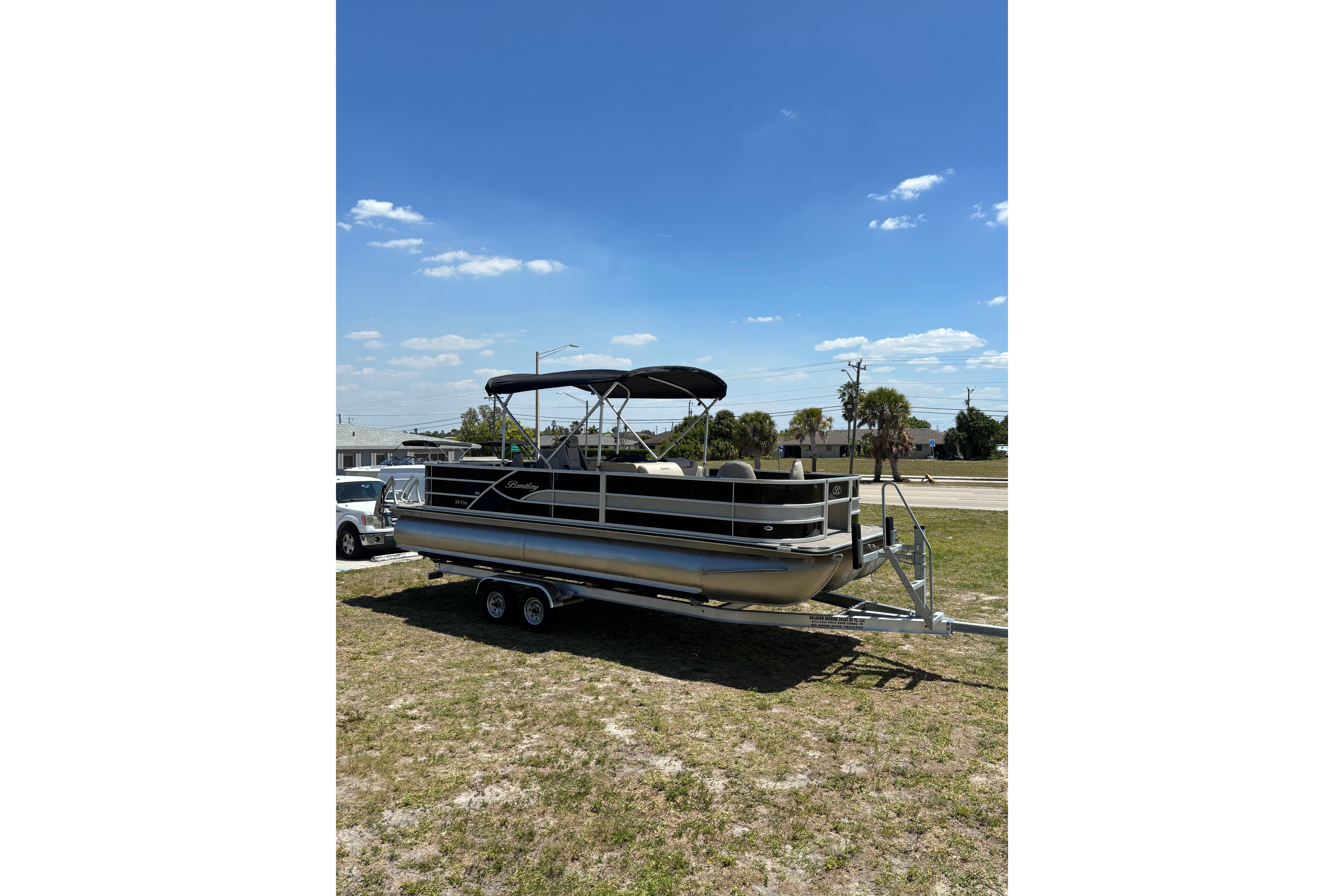 2026 Bentley Pontoons Fish 243 4-Point on trailer under sunny skies.